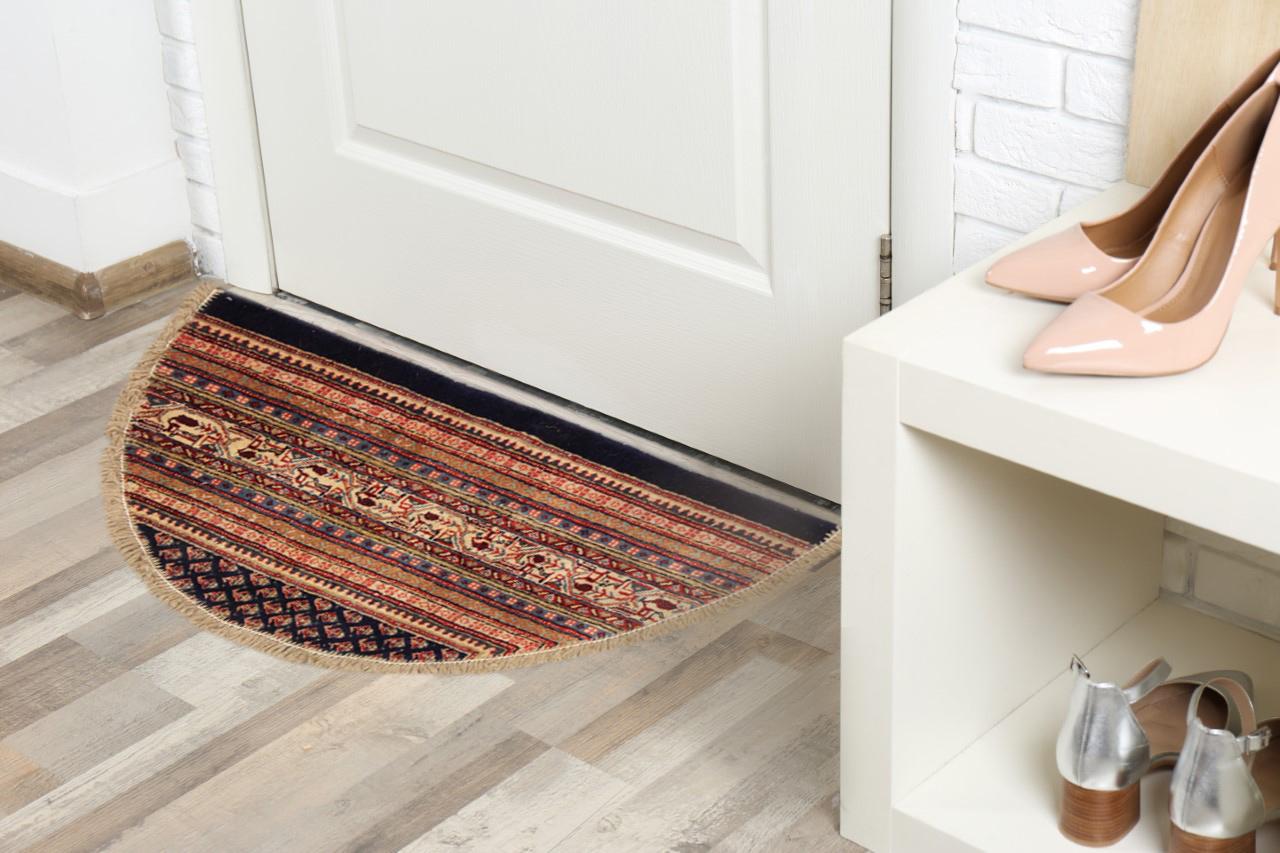 This semicircle entranceway doormat has been refurbished from a handmade vintage rug- cut from large area rugs to create these small doormats, with handwoven fringe detail. Handspun cotton and wool have been used in the construction of these mats,