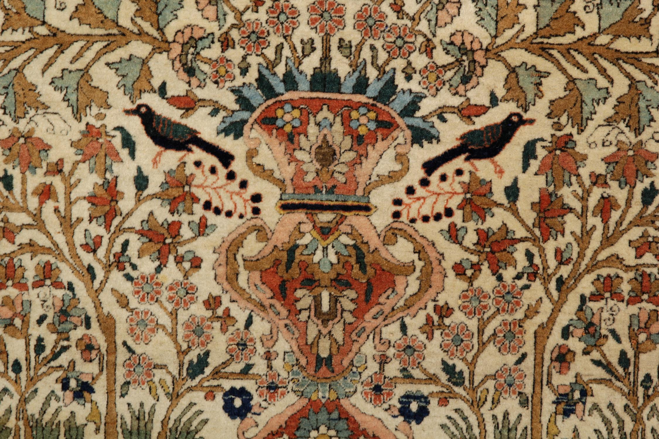 This wool rug is a fine example of antique area rugs woven in the late 19th century, circa 1880. The design features a intricately woven vase. Highly-detailed floral and botanical designs flow from the top of the vase woven in orange, blue and red