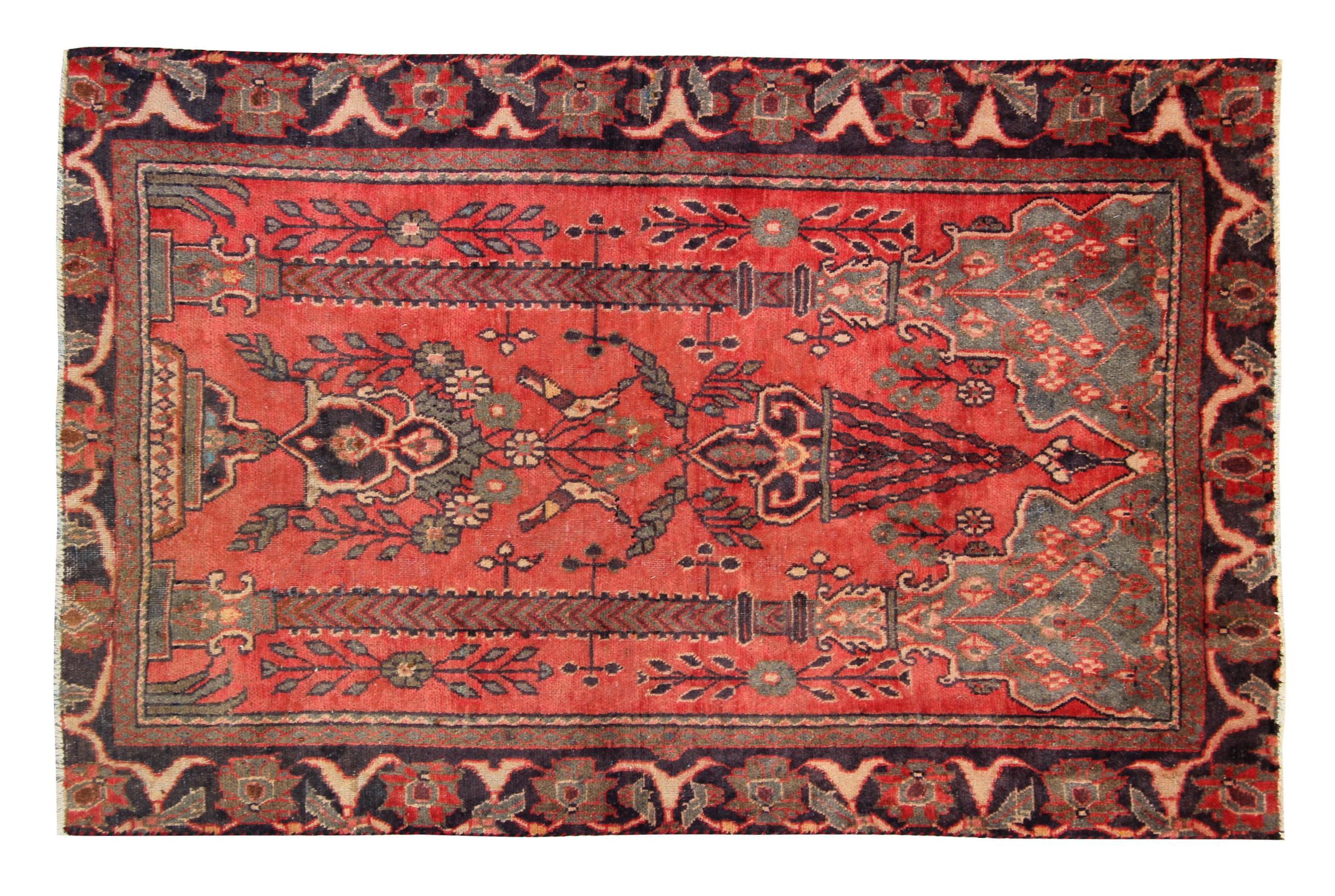 Elegantly woven with a top to bottom design, a rich pink/red background decorated with a symmetrical floral design in accents of brown, green and beige. The double pillar design and delicate floral patterns make this rug the perfect accent piece for