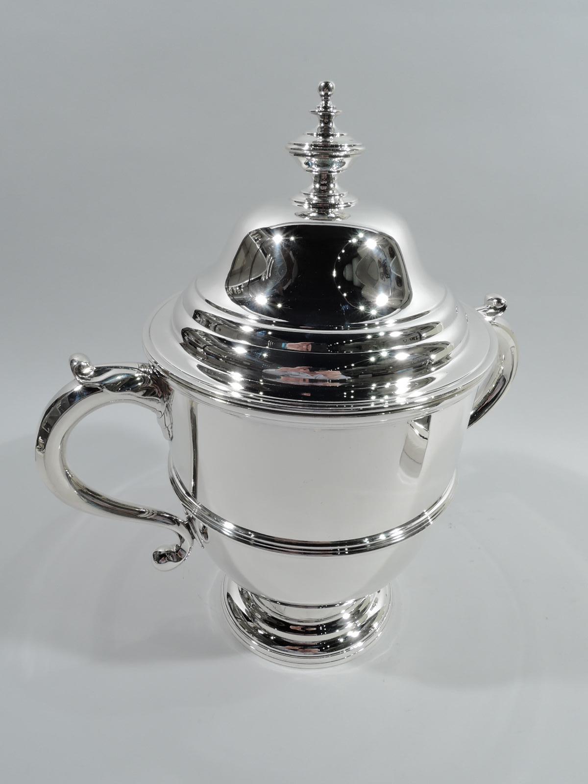 Classical sterling silver covered urn. Made by Currier & Roby in New York, ca 1920. Girdled bowl with leaf-capped s-scroll side handles, stepped foot and stepped and domed cover with vasiform finial. Traditional form with extra oomph. Beautiful