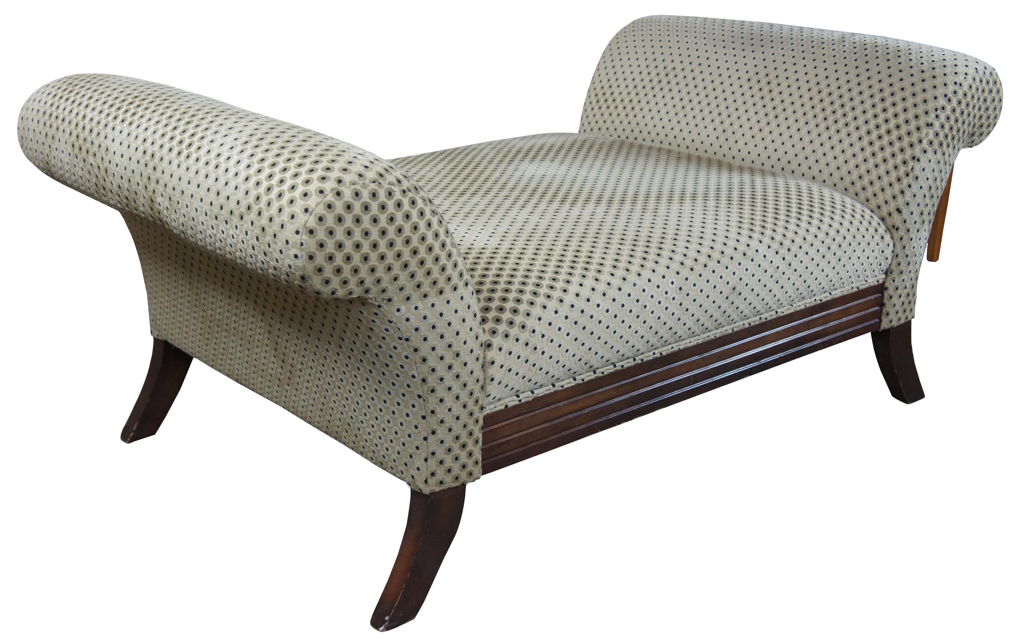 Polka dot upholstered daybed or settee. Features rolled arms over flared legs and a mahogany toned finish. Olive green and black sheened upholstery. Measure: 69