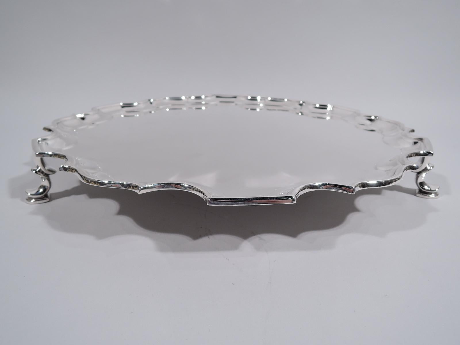 George VI sterling silver salver. Made in Richard Comyns in London in 1937. Round with molded curvilinear piecrust rim and 3 hoof supports. A handy piece in ever popular traditional Georgian. Fully marked. Weight: 40.5 troy ounces.