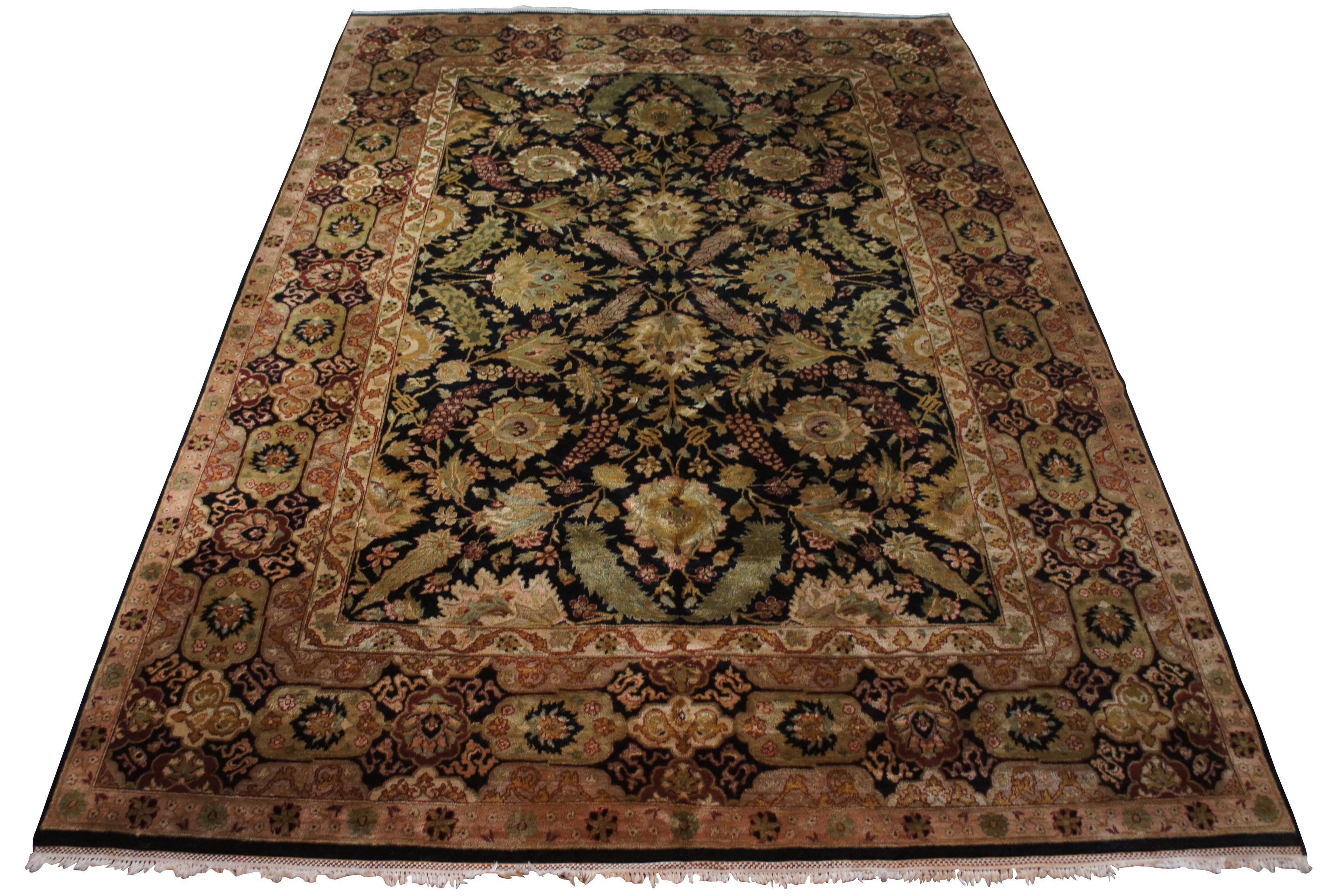 Vintage machine made area rug carpet featuring floral design with black field and flowers / pinecones with greens, tans, gold, pink, reds and grey. Measures: 10' x 14'.
  