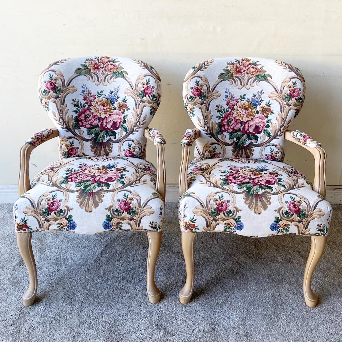 Amazing pair of vintage arm chairs. Each feature a floral upholstery with a wooden frame.
 
