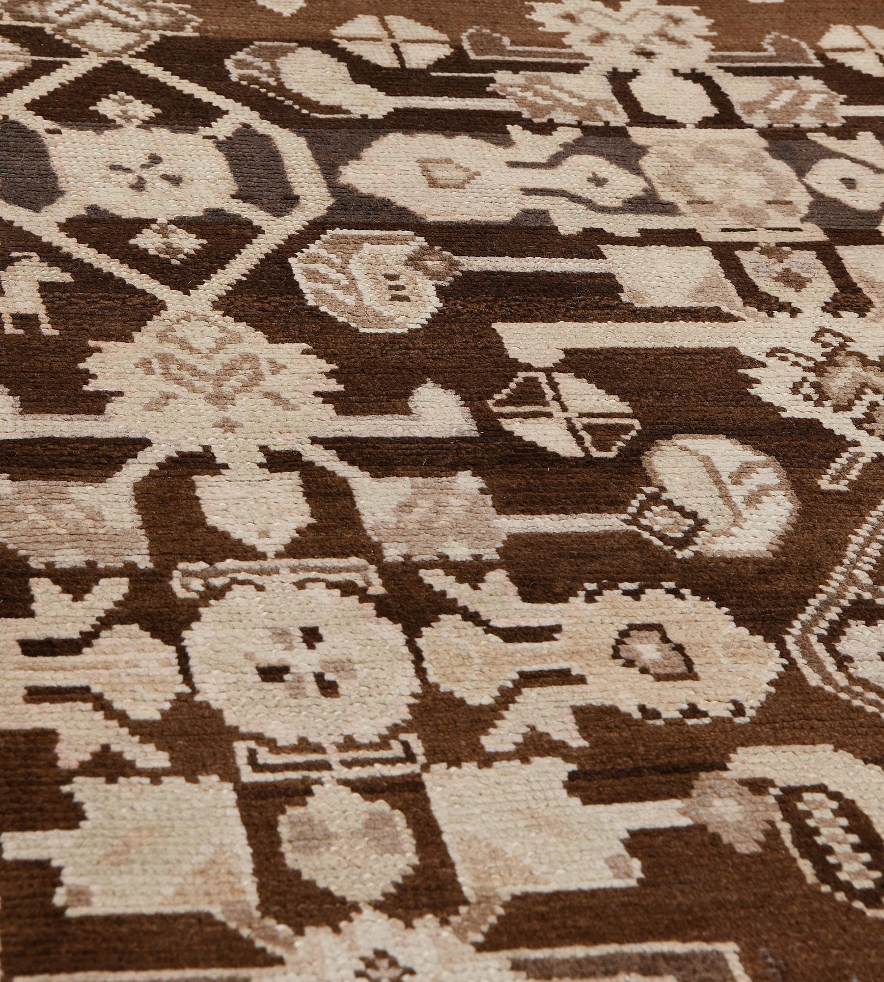 This traditional hand-woven Persian Karabagh rug has a dark tobacco field with an overall counterposed stylized geometric herati pattern, in a sandy saffron border with geometric floral motifs, between geometric stripes, plain outer delicate sandy