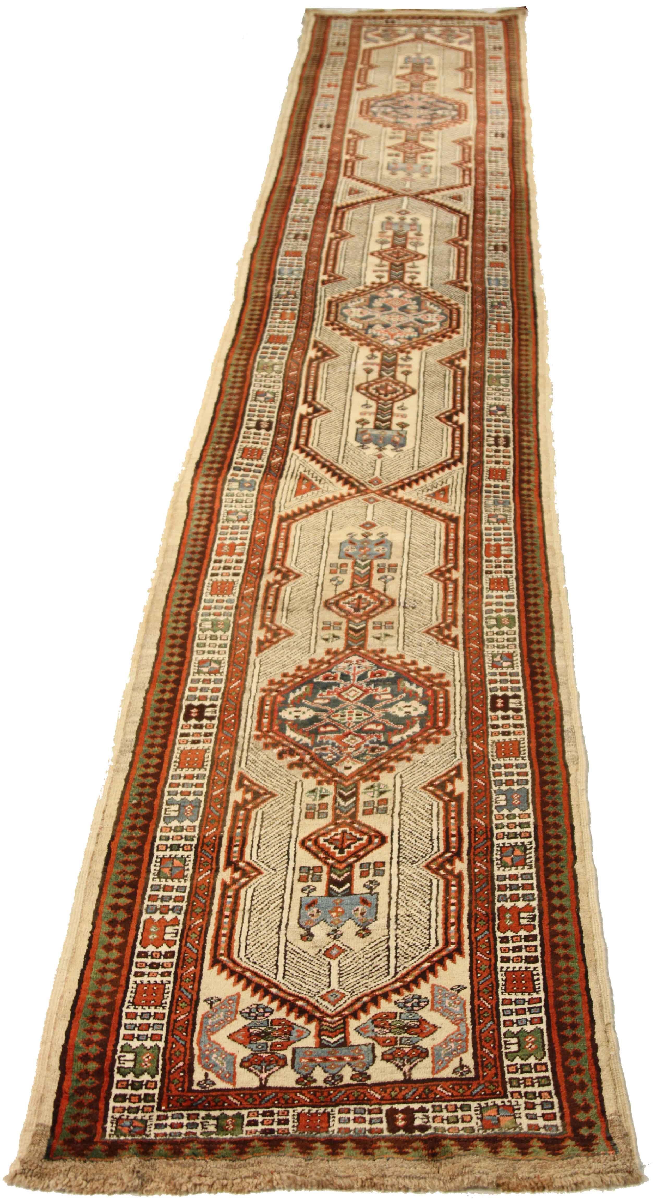 Geometric patterns infused with a tribal color motif make this antique Persian rug desirable for any space. Its foundation is made from the finest quality wool which has allowed it to keep its pristine condition despite being close to a century old.
