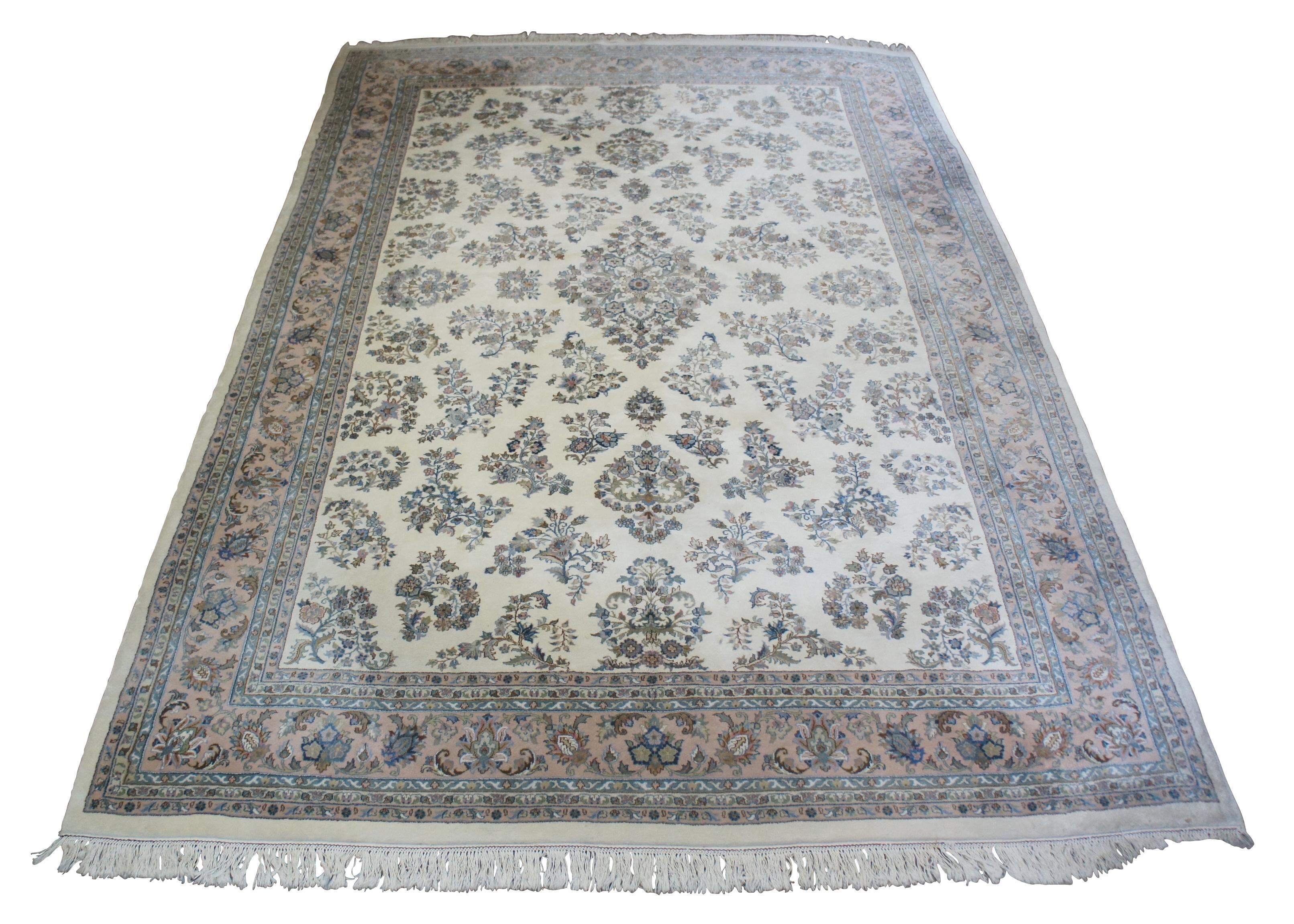 Vintage Indo area rug by Royal Rugs, circa last quarter 20th century. Handmade from 100% wood. Features a floral all over pattern with beige/creme, peaches and blues. Royal rugs has been in business since the 1950s. The company was started by a