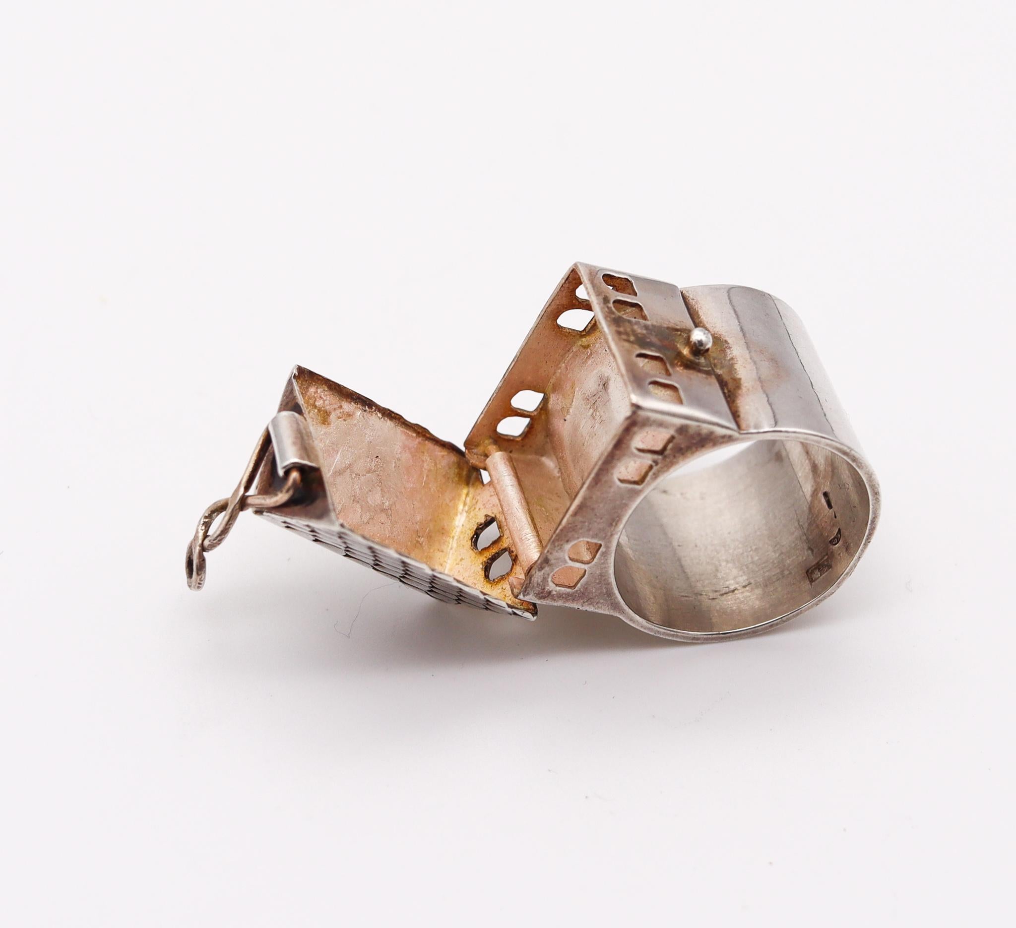 Hebrew wedding house-box ring.

A vintage three-dimensional piece, crafted in solid .925/.999 sterling silver. This traditional Hebrew wedding ring was made up in the shape of a house and fitted with a secret compartment with a hinged lid and a