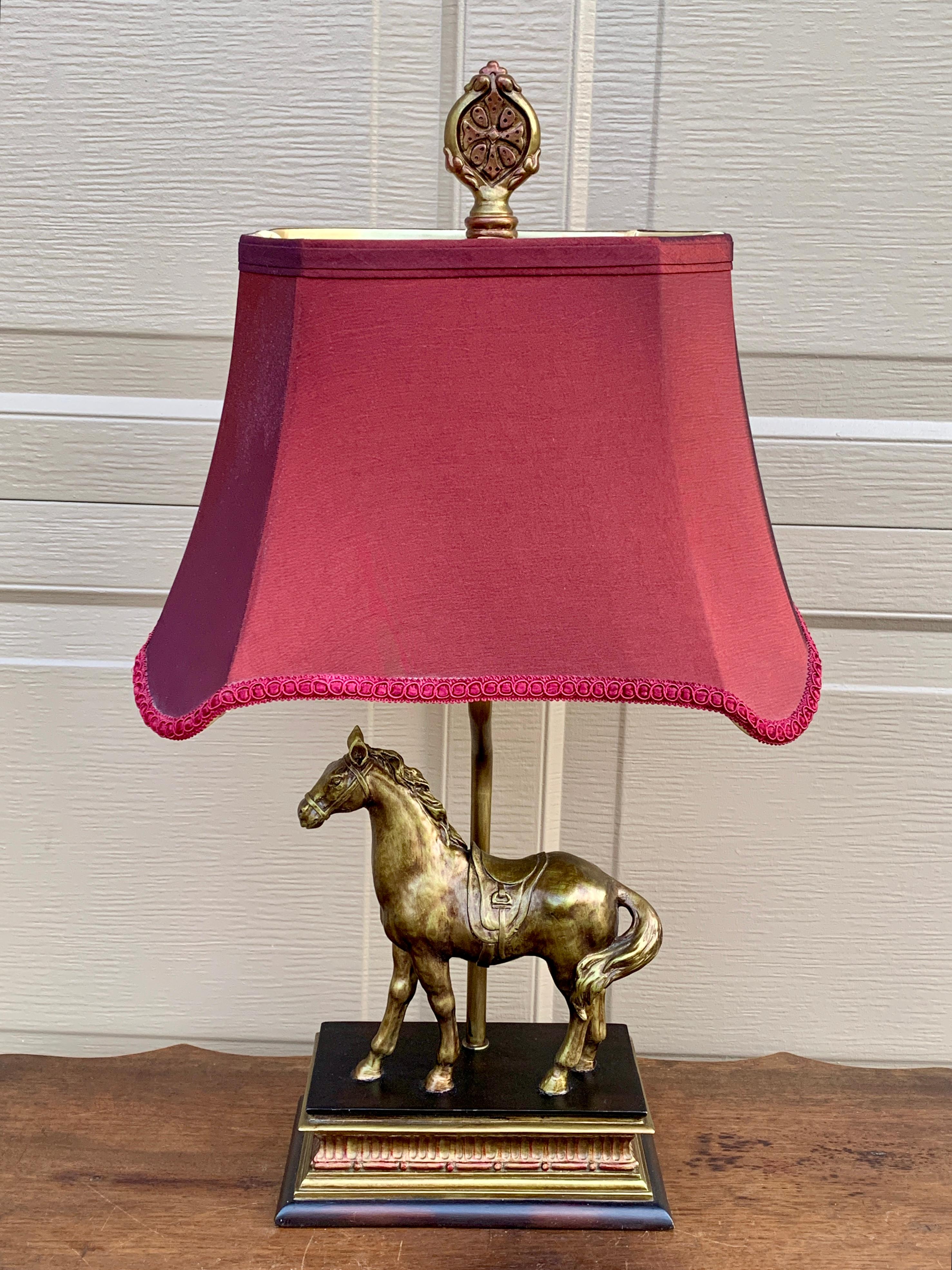 A gorgeous English Country style equestrian lamp featuring a horse and a cranberry colored fabric shade

USA, 21st Century

Measures: 13