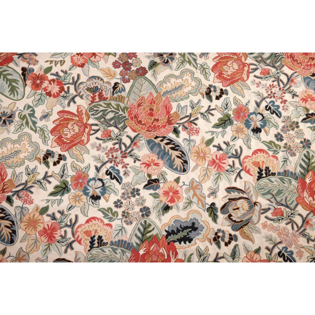 Traditional Indian Wool Chain Stitch Decorative Area Rug, Kashmir Valley, India. Hand embroidered on a cotton and linen blend background and backing. A bright floral design of orange hue blossoms on a bed of green foliage surrounded by a smaller