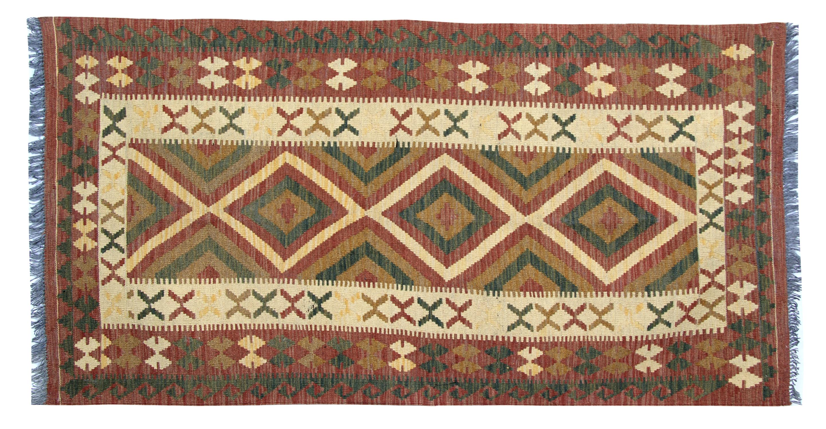 This beautiful tribal Kilim Rug features a rustic colour palette including brown, cream green and beige. These elegant colours have been woven by hand into an asymmetrical diamond medallion central design with a layered repeat pattern border. Woven