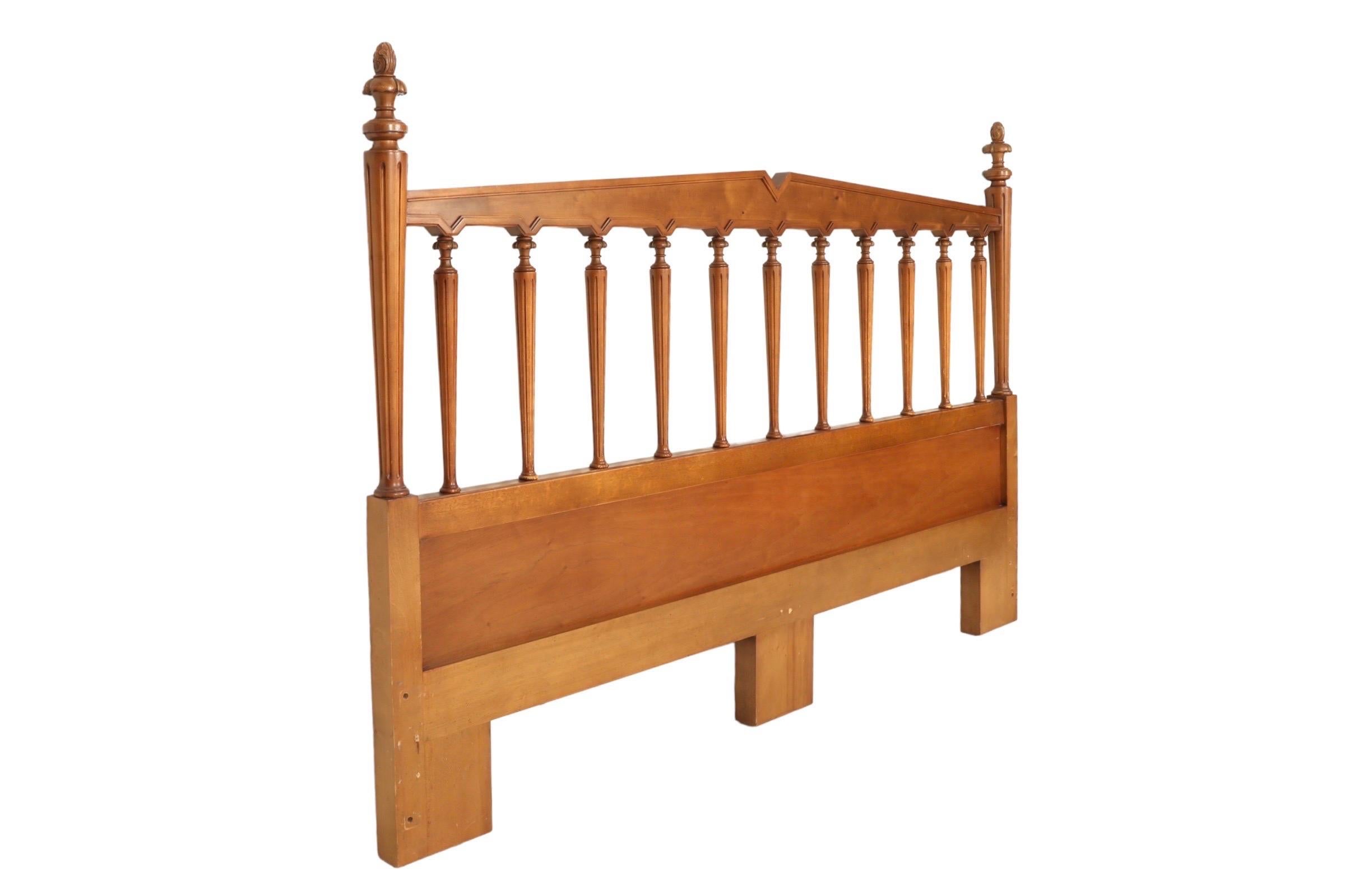 A custom made king size headboard made of maple. Clean beveled lines form a traditional crest rail supported with 11 turned posts. Outside posts at each end are topped with acanthus frills and acorn finials. In the back reads “Custom built to