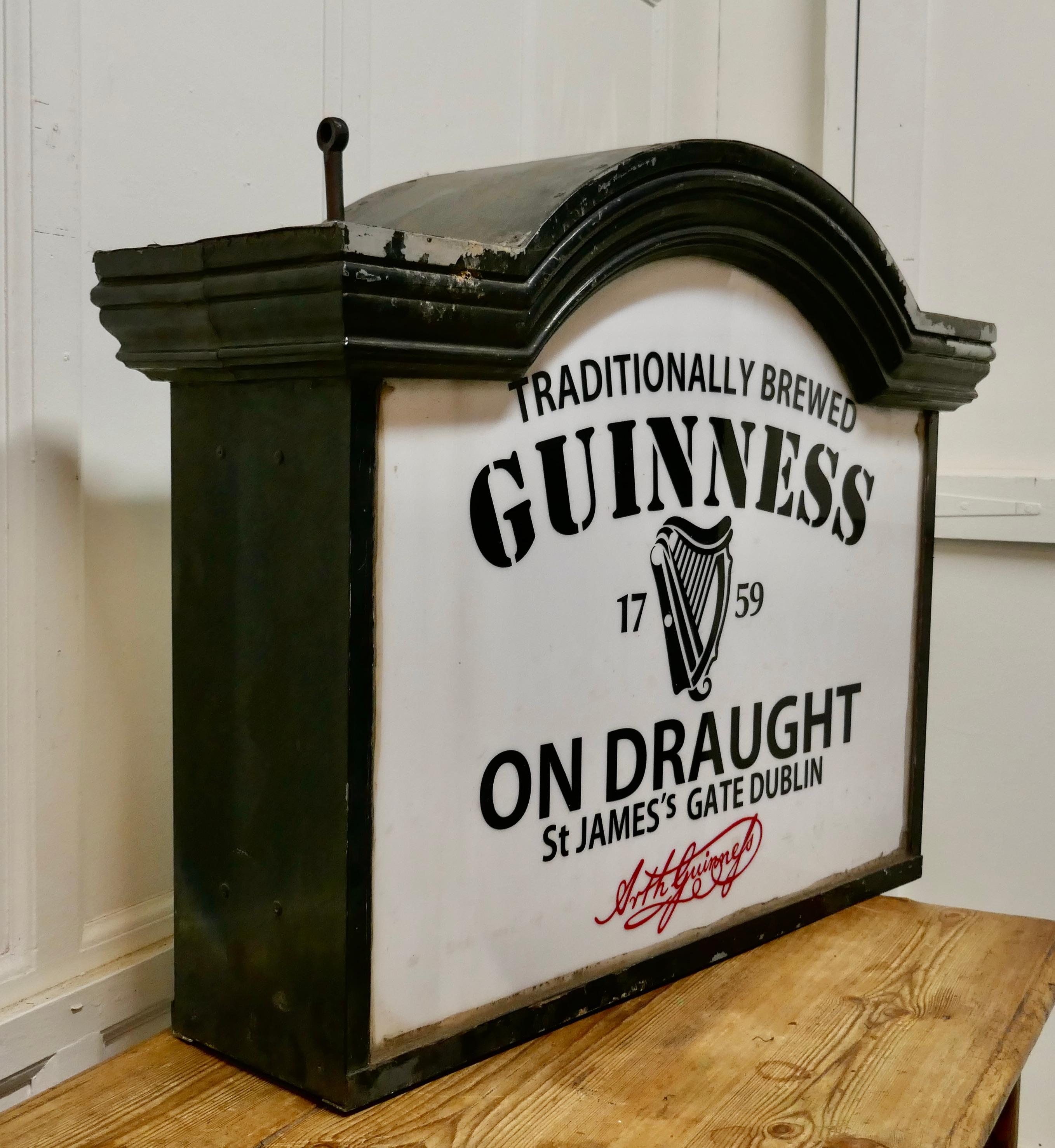 Traditional large Guiness hanging pub light from the 1950s.

This is a large piece dating from the mid-20th century, the light is double sided it has an arched top, and would have been suspended from a wall bracket
The electrics have not been