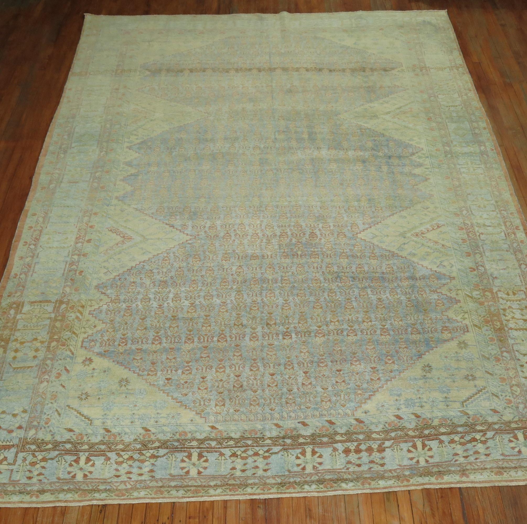 Room size Persian Mahal carpet with beige diagonal medallions and corner spandrels on a light blue all-over field accents in pale green and rust too, circa 1920.

Measures: 10'1” x 13'5”.