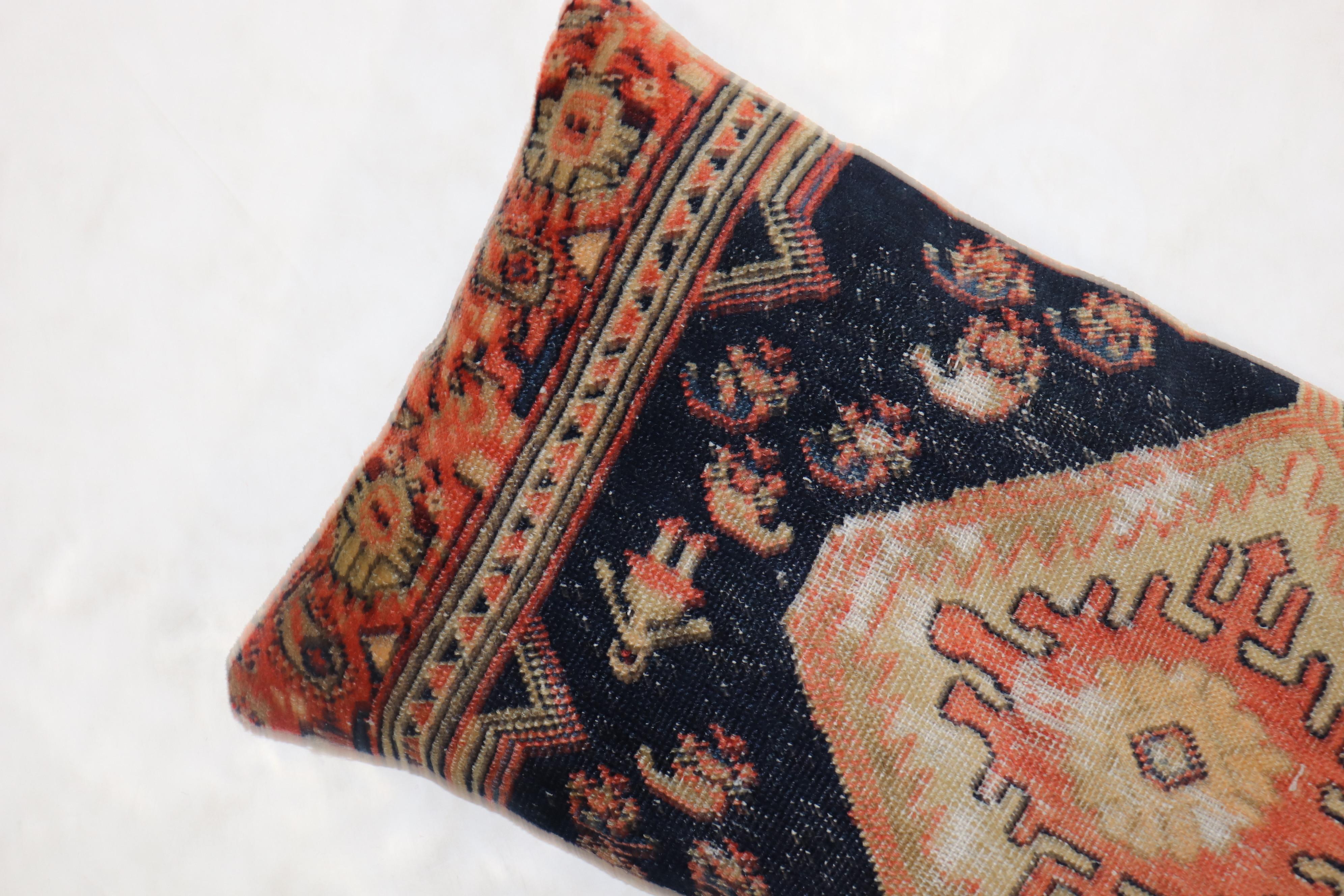 Pillow made from an antique Persian Hamedan Tribal rug with a cotton back and zipper closure included.

Measures: 15” x 31”.