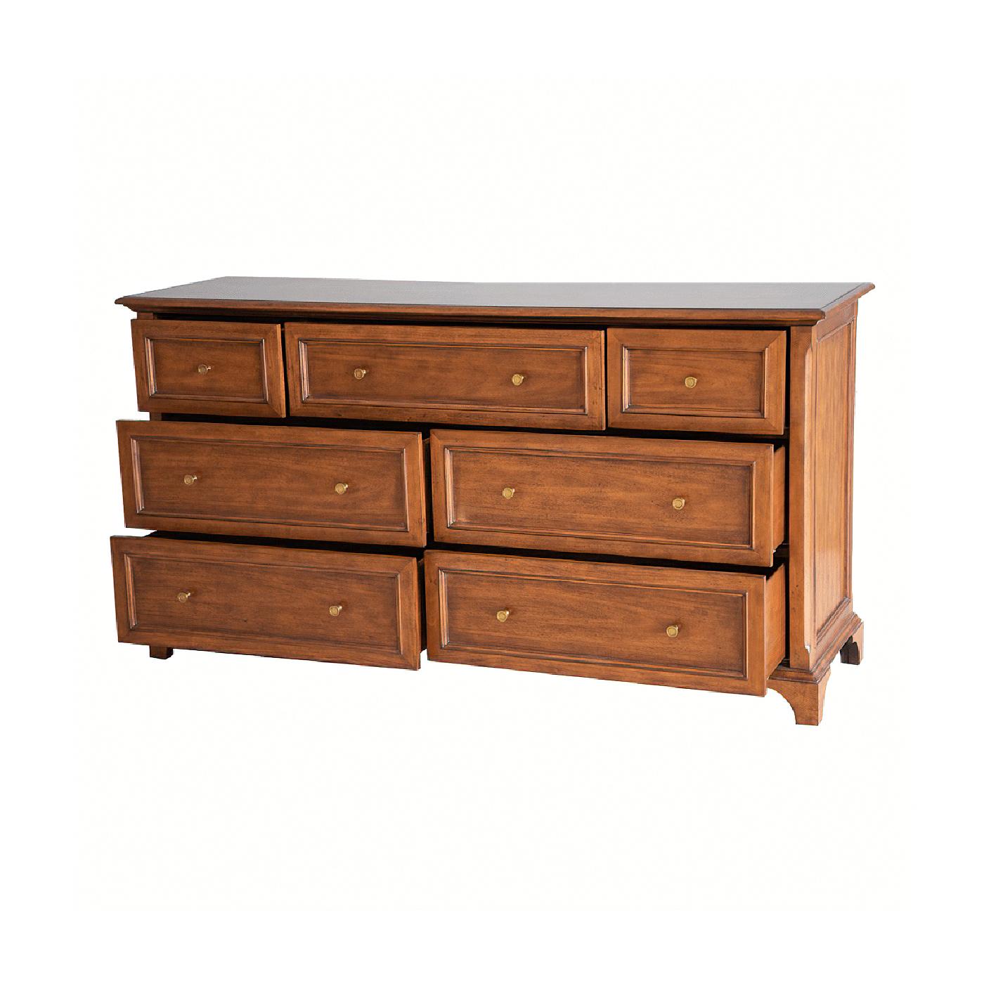 Traditional long dresser with an Ogee edge top, beveled decorative trim corners, hand-cast brass knobs, raised on bracket feet with a hand-rubbed warm rustic wood tone lightly distressed finish.

Dimensions: 68