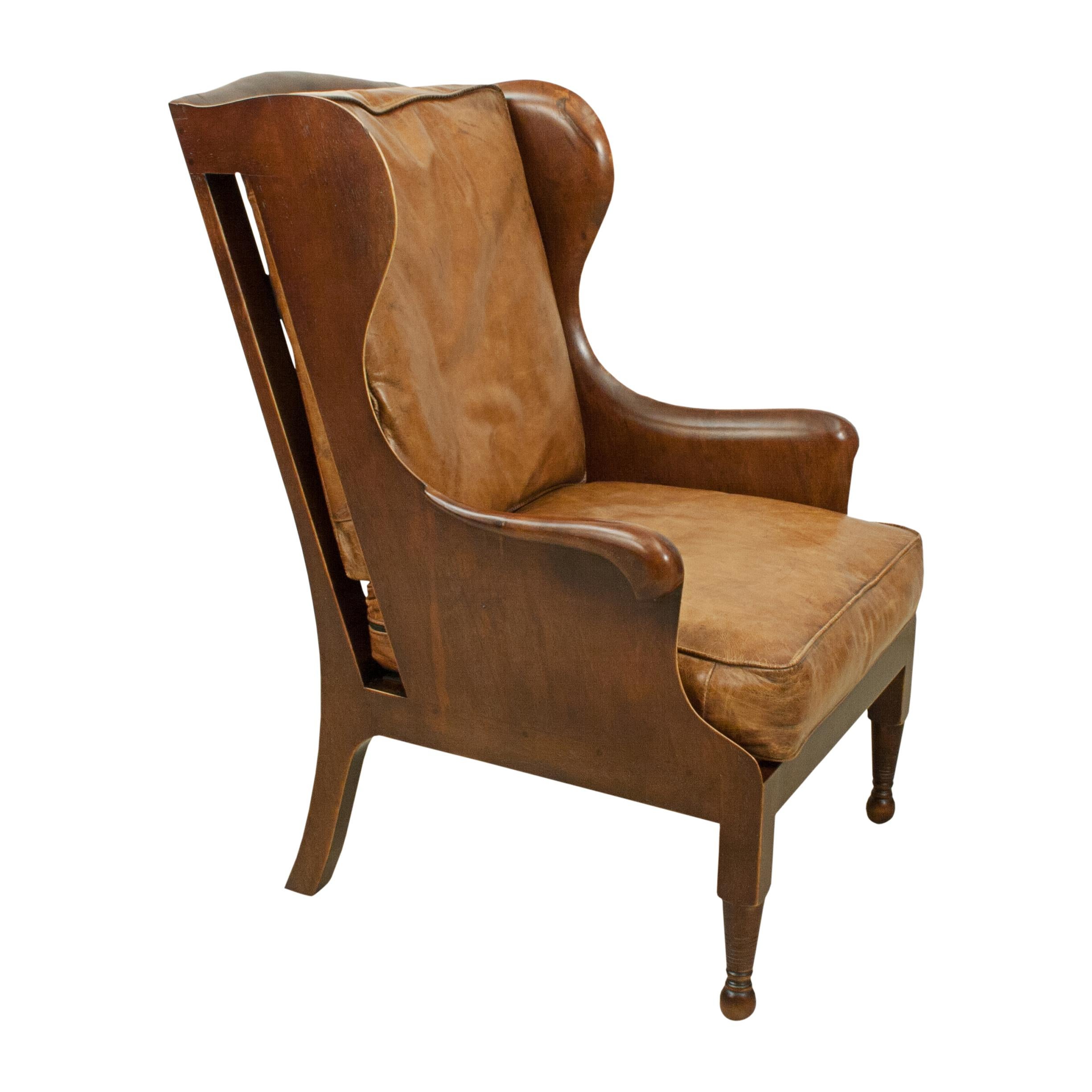 Mahogany wing armchair with leather seat and back.
A very nice well proportioned high back wing armchair made of mahogany with tan leather seat and back cushion. The chair is raised on turned front mahogany legs with square legs to the rear and a