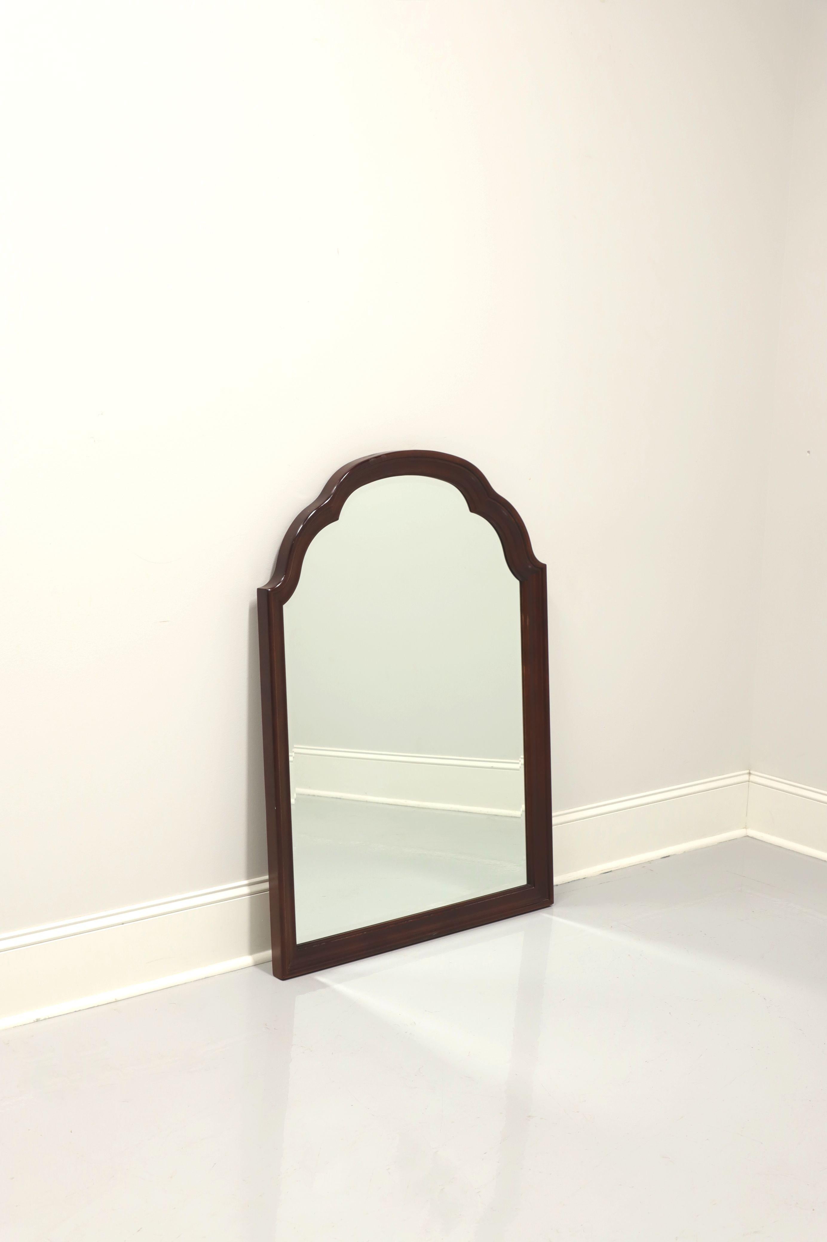 A Traditional style wall mirror, unbranded, similar quality to Craftique or Henredon. Beveled mirror glass and mahogany frame with scalloped arched top. Made in the USA, in the late 20th Century.

Measures: 32 W 1.75 D 44.75 H, Weighs Approximately: