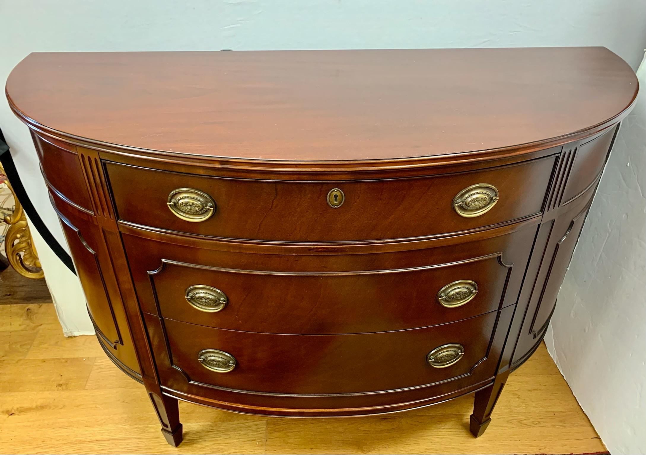 Classic high quality mahogany chest of drawers with curved front and three spacious dovetailed drawers with original brass plates. Well crafted, Made in the USA.
