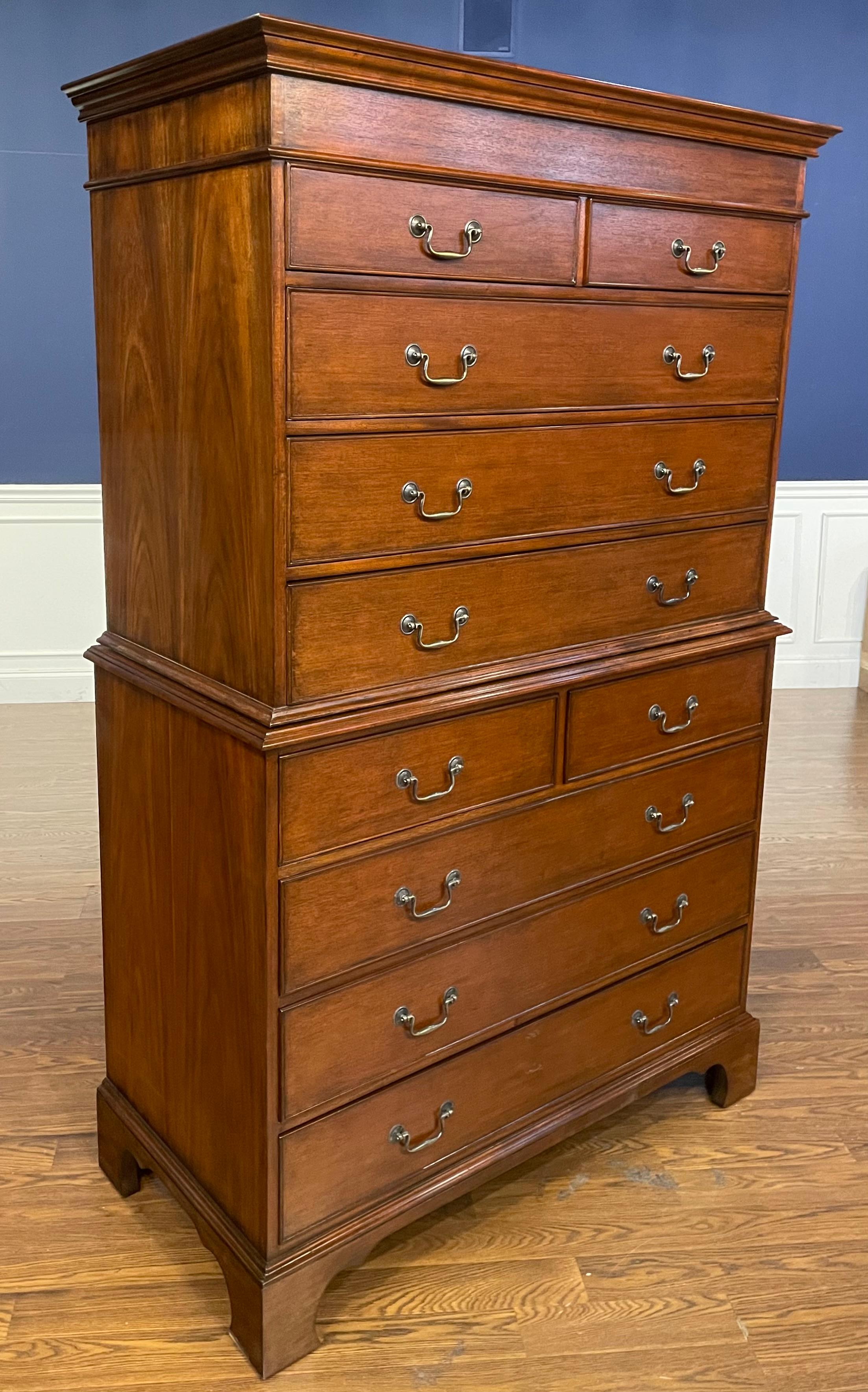 This is a traditional mahogany Chest-On-Chest by Leighton Hall Furniture.  It features classic Chippendale styling, ten dovetailed drawers and antique brass pulls.  It has a medium brown mahogany color with a satin finish.  This chest was used
