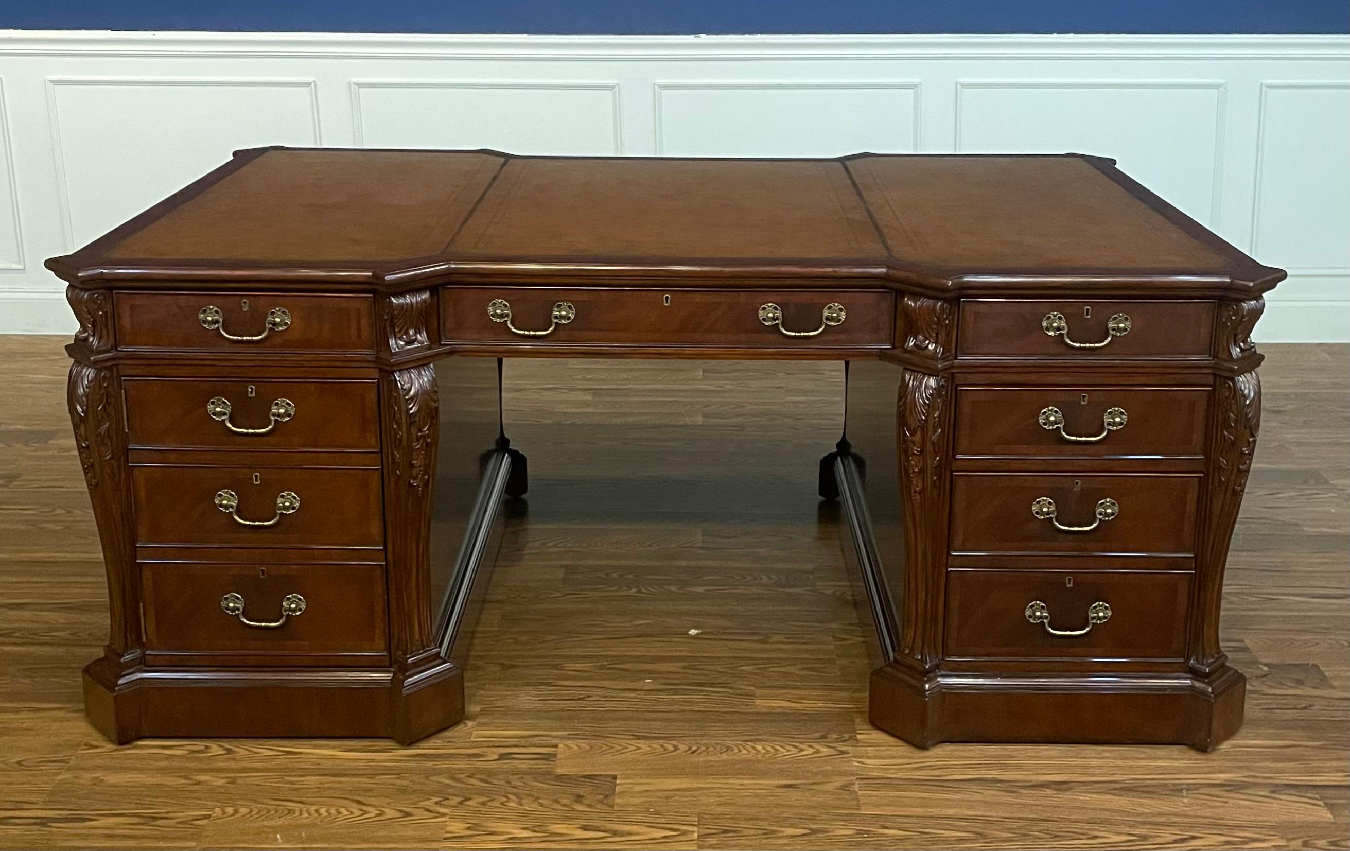 This is a new traditional mahogany partners desk. Its design was inspired by partners desks from the 1800s. It is ideal for the senior partner, CEO or home office. It features a top of brown leather with gold tooling. Its front, back and side panels