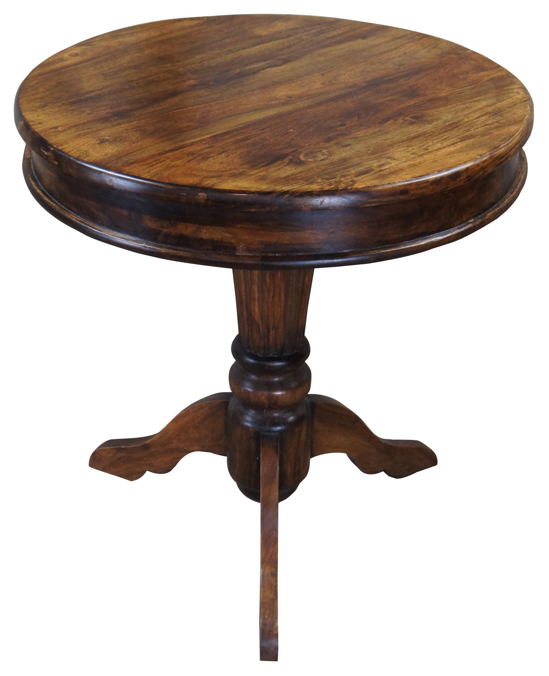 Traditional drum table. Made from mahogany with round top over fluted column and tri-leg base. Measure: 30