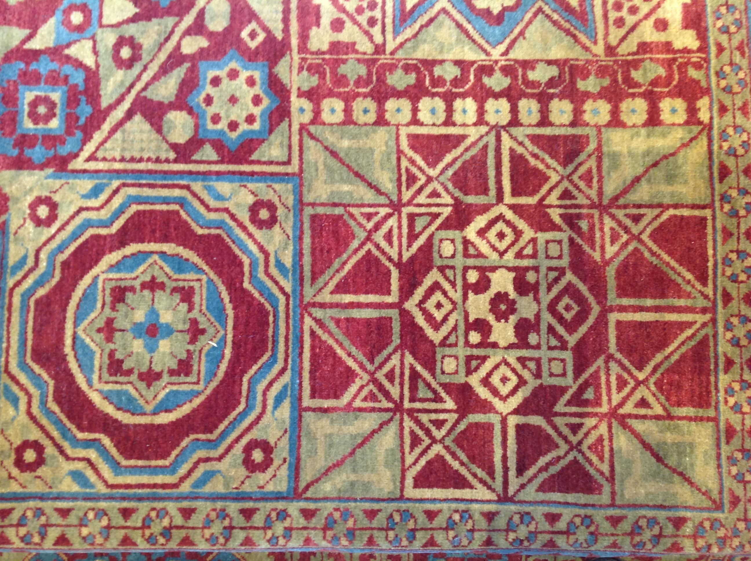 For centuries Mamluk rugs have been known by their distinctive geometric designs and this contemporary Indian-made example is no exception. A variety of shapes in deep red, dark tuquoise blue, dark gold and green come together to create an