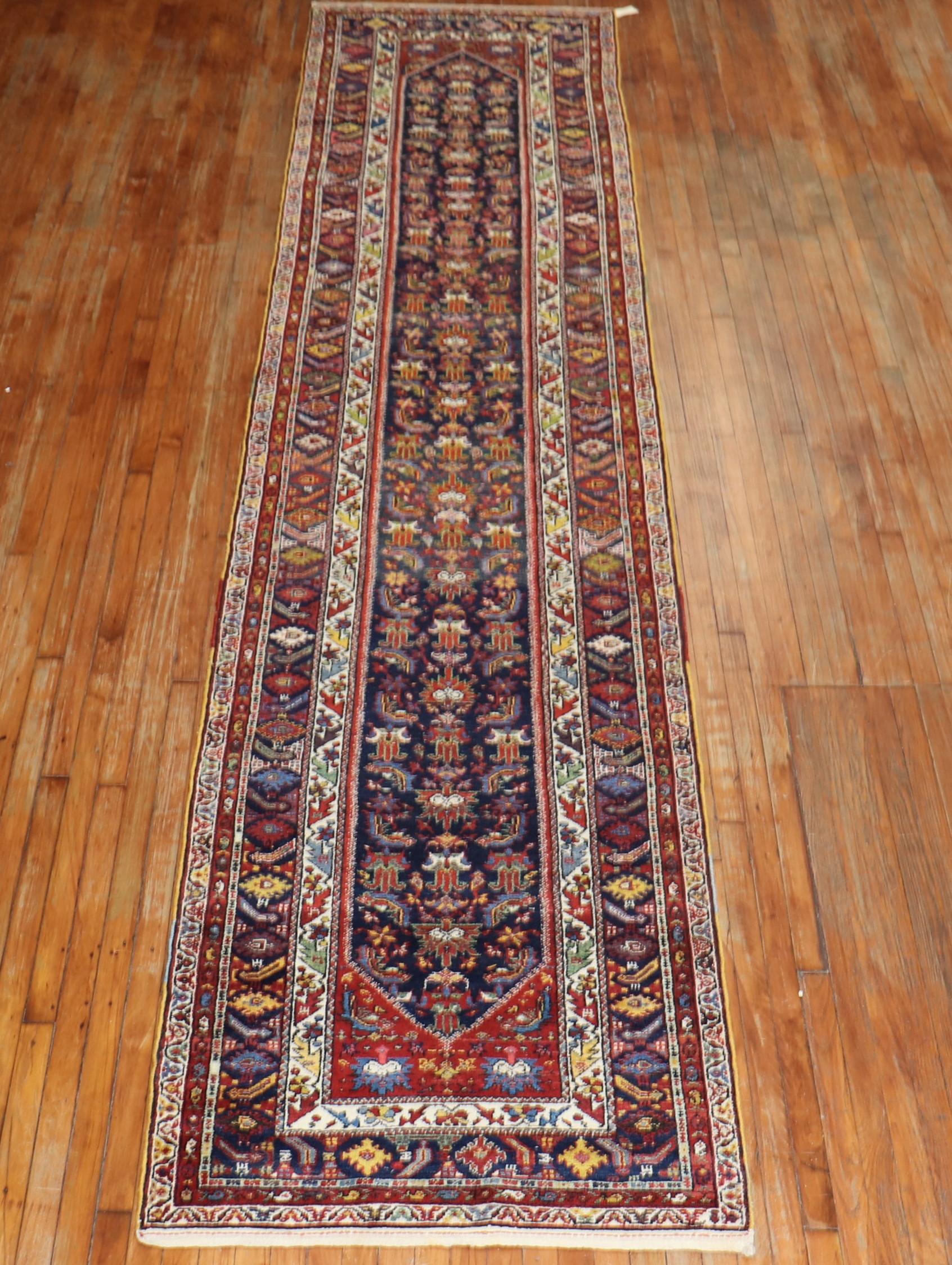 A traditional navy field Persian Malayer runner from the early 20th century.

Measures: 3'4” x 15'4”.