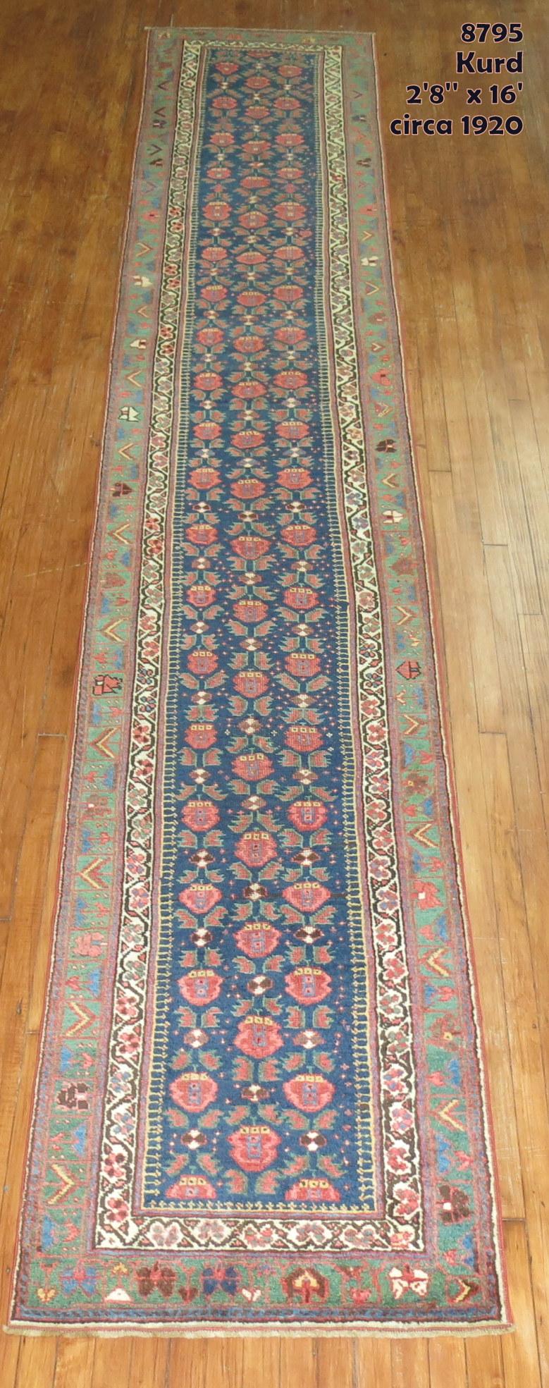 A narrow and long Persian runner with a floral design on a navy field, the border is green. Lot of different accent colors, predominantly in brown, rust, ivory and light blue, circa 1930.

Measures: 2'8