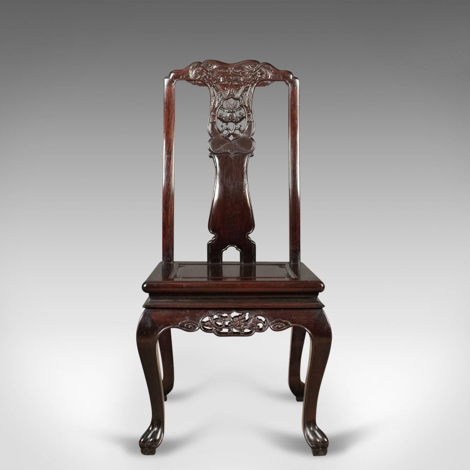 This is a traditional, oriental rosewood set of four dining chairs, a carved suite
of fine quality crafted in the late 20th century, circa 1980.

Entirely made from solid, and heavy, rosewood with a hand applied dark cherry finish
Profusely