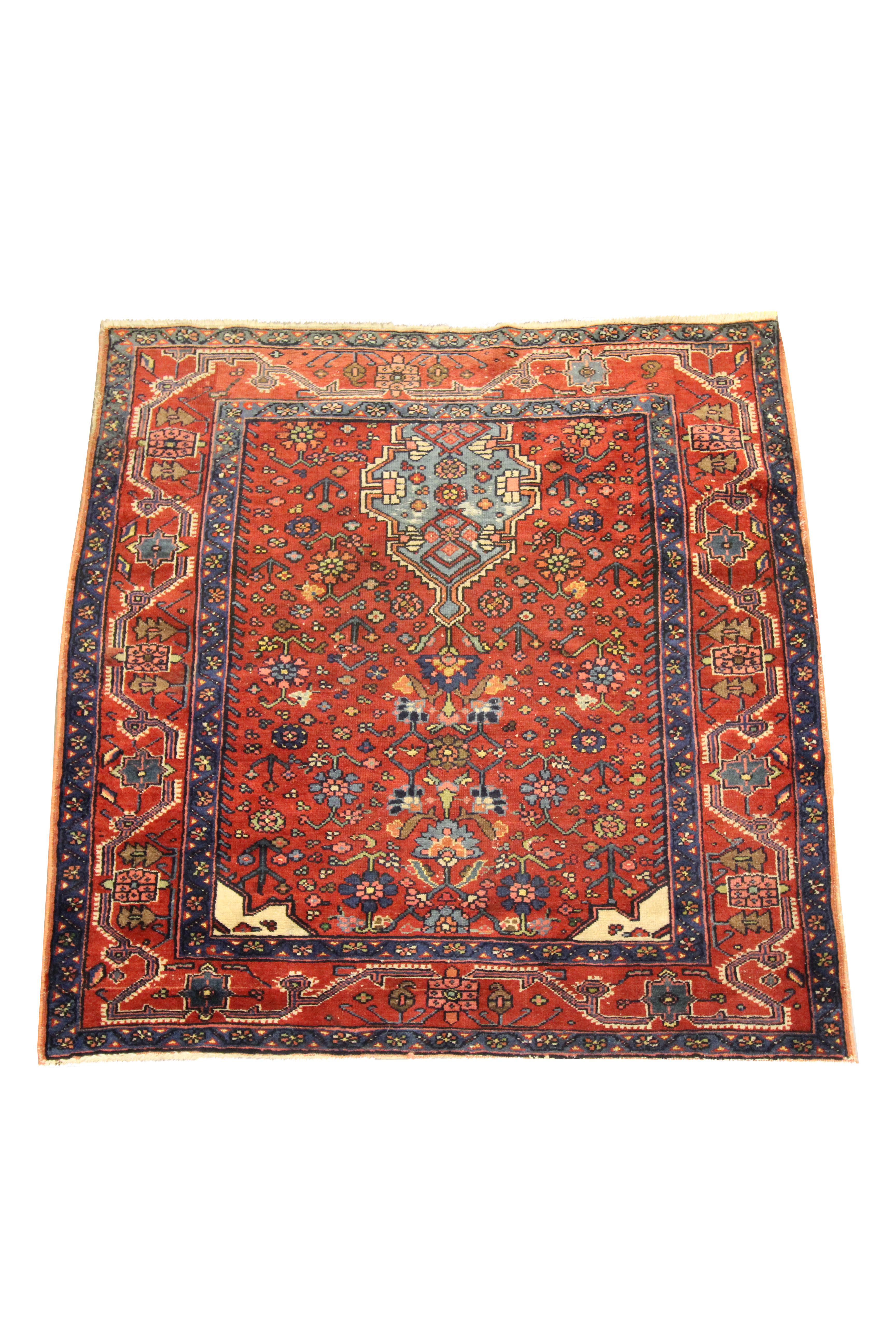 This fine wool area rug is an excellent example of carpets woven in the late 19th century, circa 1880. The design features a traditional tribal pattern with native motifs woven throughout on a rust-red background in accents of blue, green, orange