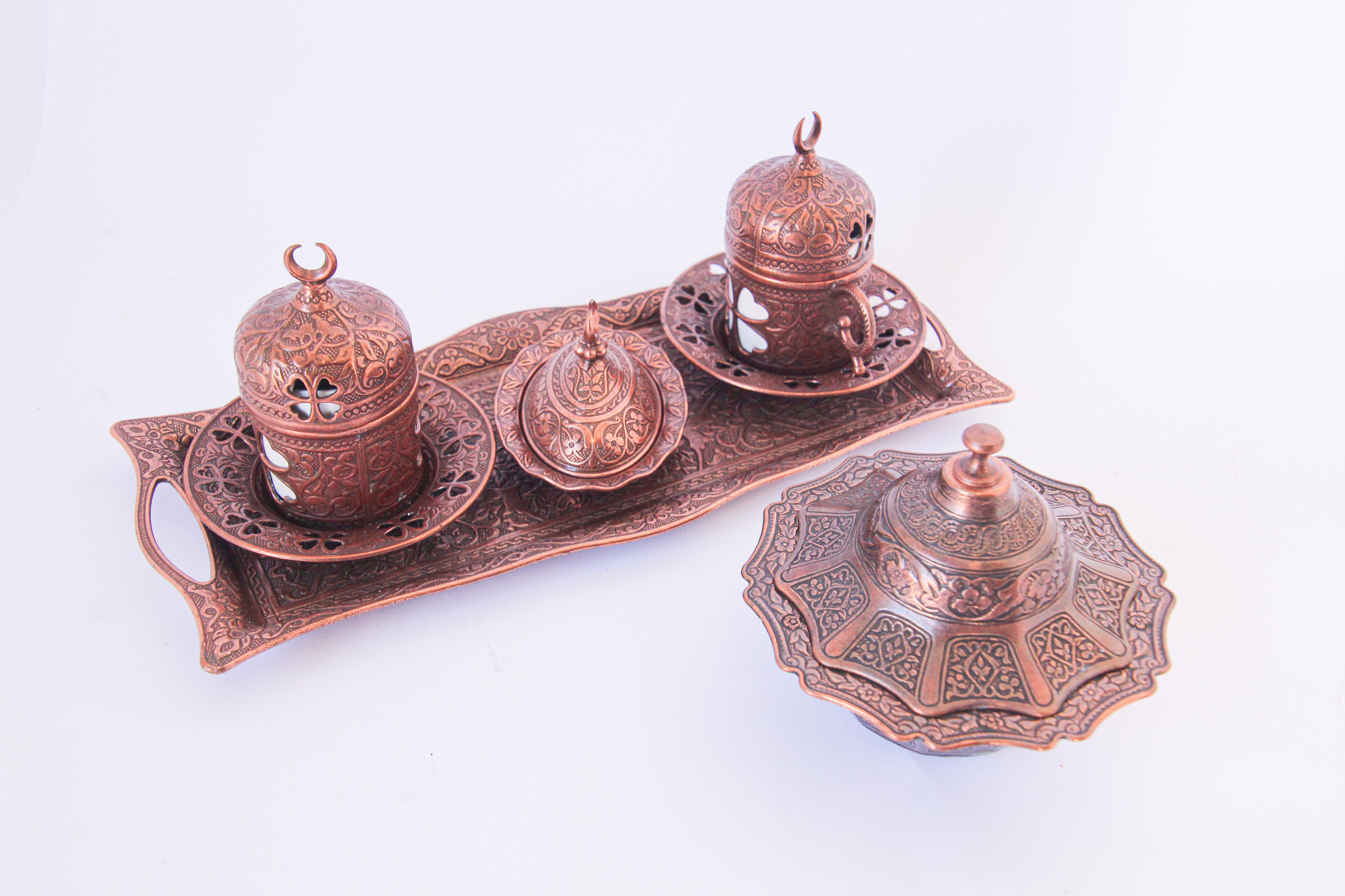 Traditional handmade ottoman copper cast metal Turkish coffee set.
One tray with 2 coffee cups, saucers, and 2 small covered dishes for sugar or sweets.
The cups hold 2 oz. Ideal for Turkish, Greek, Arabic coffee and Espresso.
Porcelain cups are