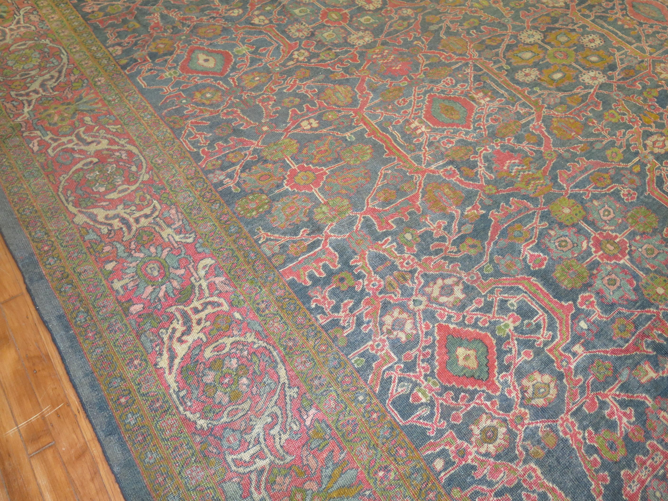 Large size early 20th century antique Persian Mahal rug with an all-over large scale geometric design a gray blue fieldpink border. Dominant accents in green, brown and pink

Measures: 13'1” x 17'5