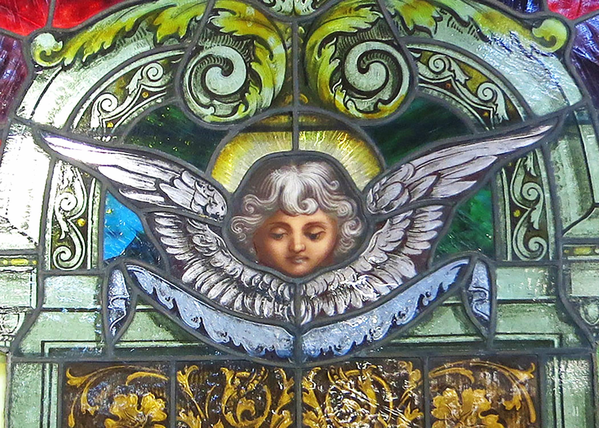 Traditional painted laminated stained arched glass windows with lead joints.

The window features a Cherub within the center surrounded by a pair of columns topped with an archway.