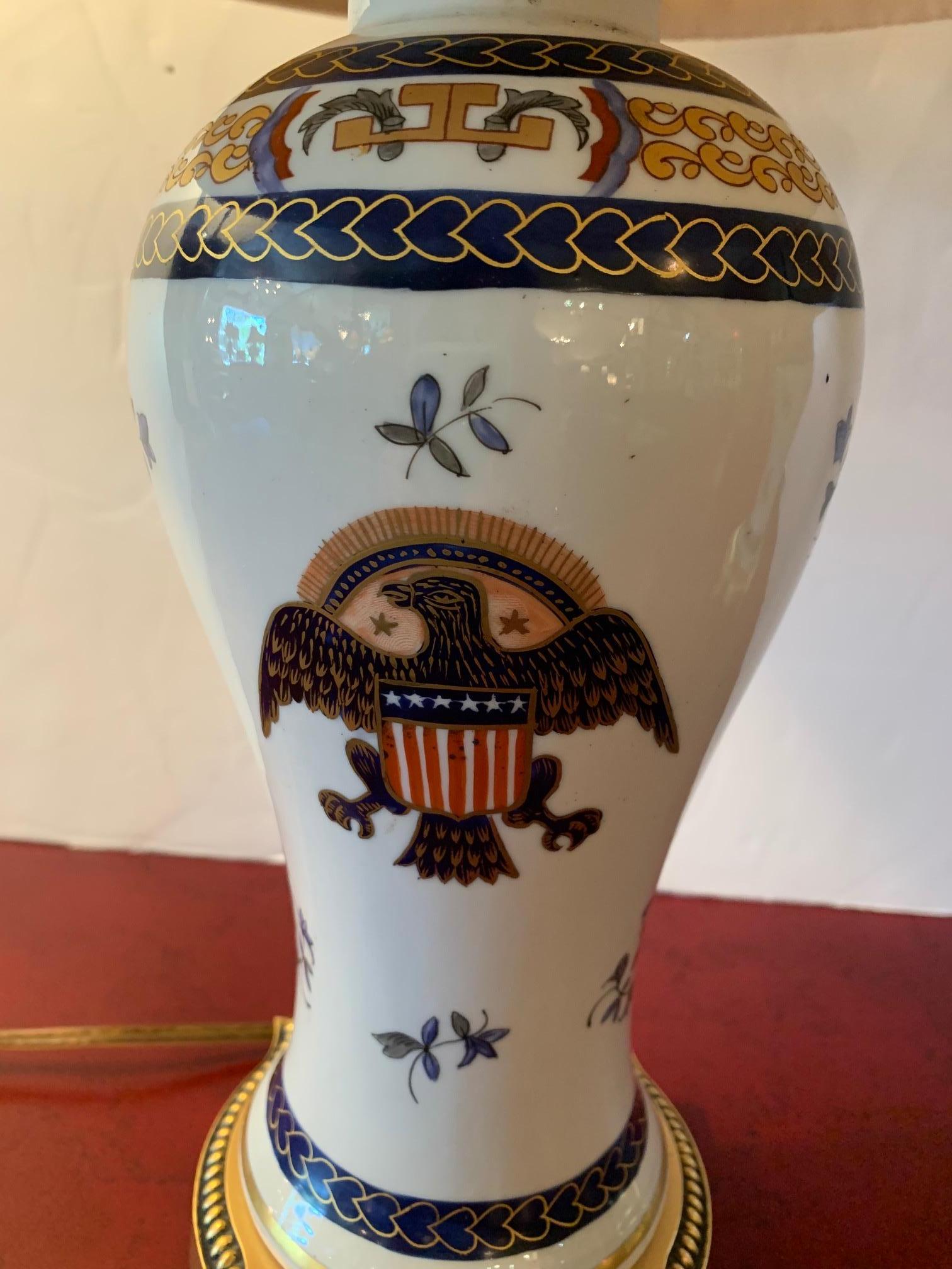 Pair of traditional Chinese porcelain table lamps having white background and patriotic eagle crest with red white blue and gold color palette.
Lamps are 5” diameter
Double sockets.
   