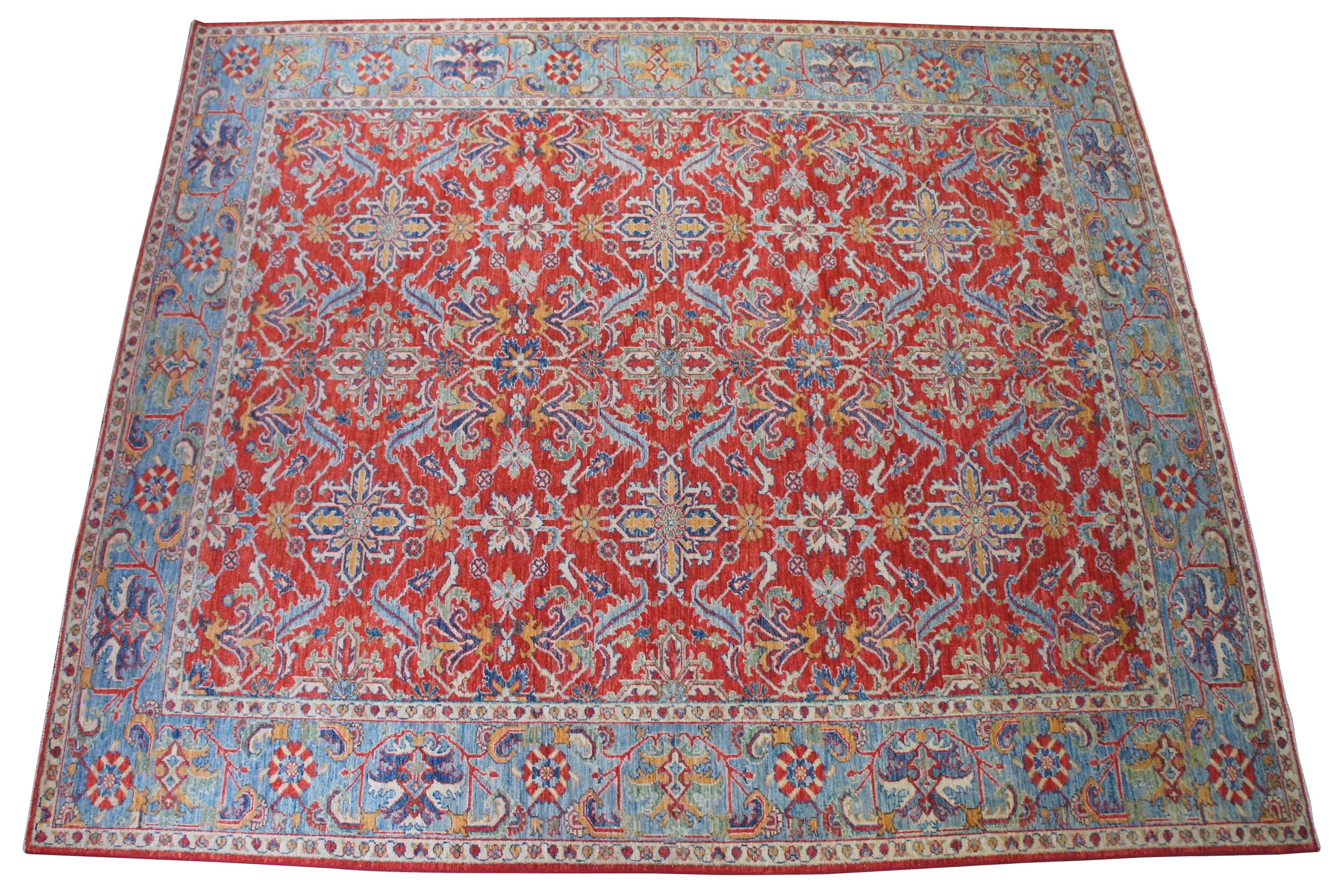 Vintage Pakistan area rug or carpet featuring florals / hearts and a field of red with blues, greens, orange and tan. Measures: 8.5' x 9.