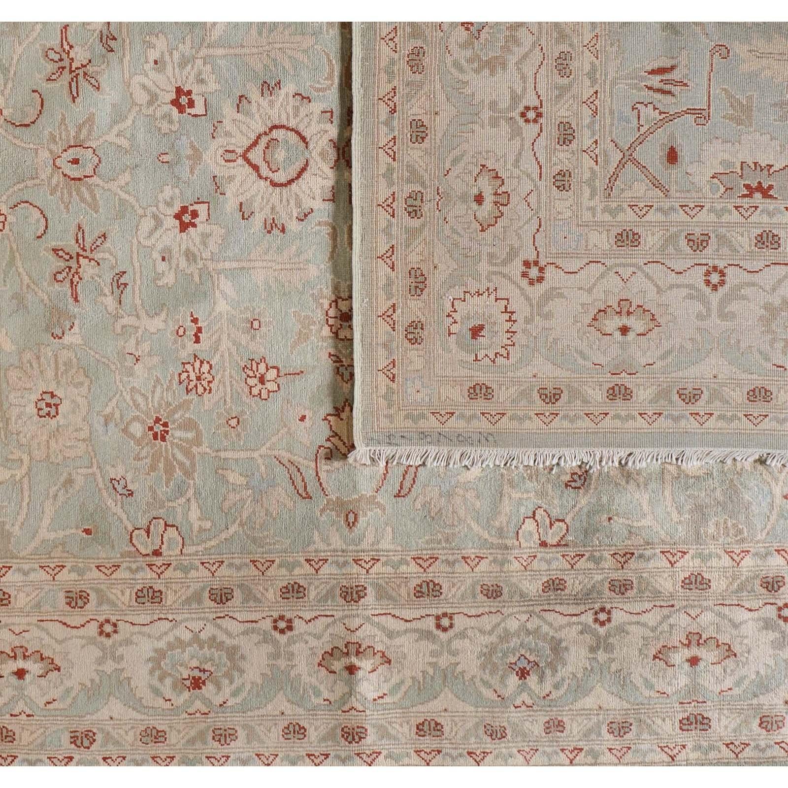 Light sage green provides the backdrop for a floral pattern blending cream, taupe and red in this traditional Pakistani rug with a contemporary feel. Wool. Hand knotted in Pakistan using vegetal dyes.