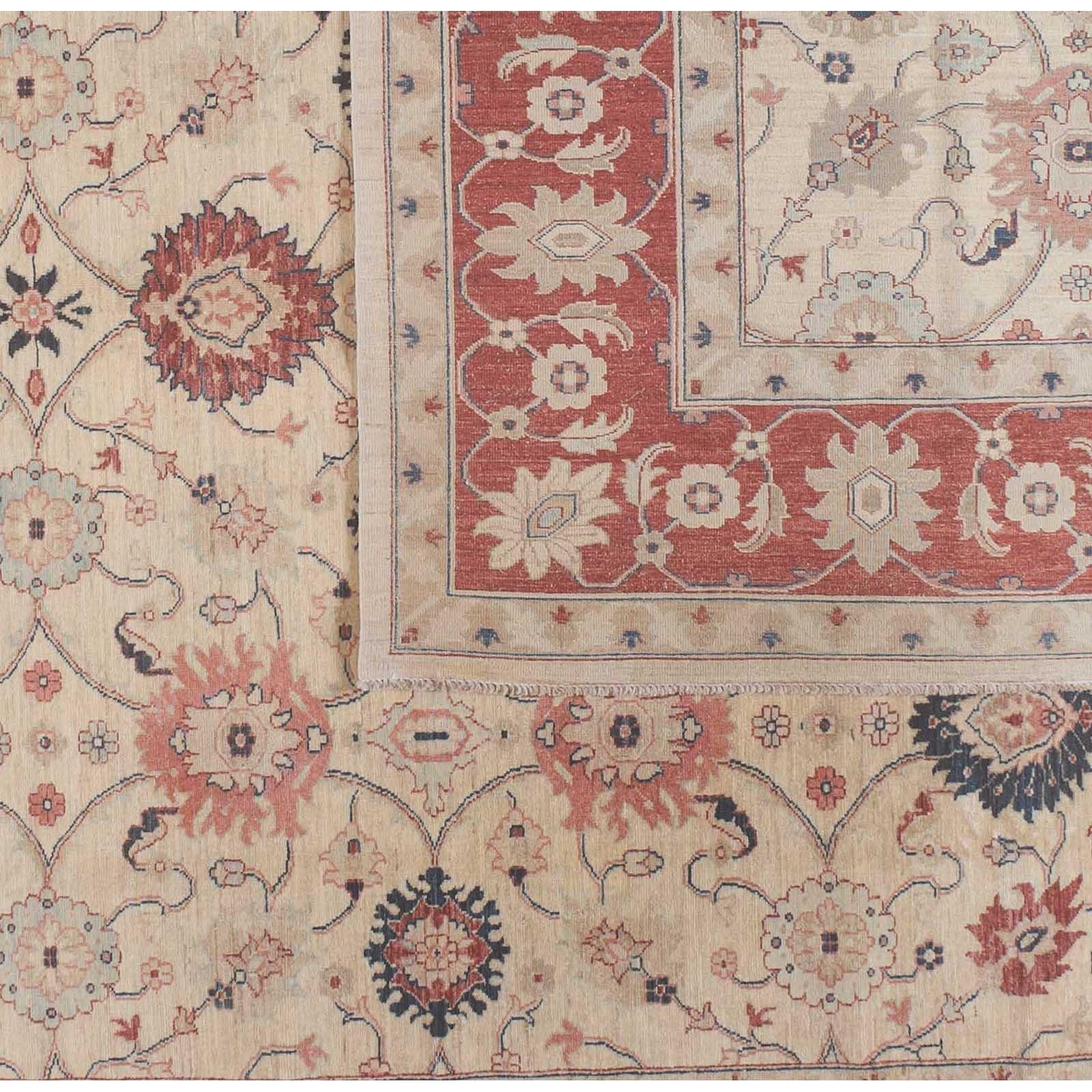 A bold red border surrounds a beige floral center in this traditional Pakistani design. Red, coral, teal and taupe flowers delight without distracting in a piece with lovely balance and proportion. Wool. Hand knotted in Pakistan using vegetal dyes.