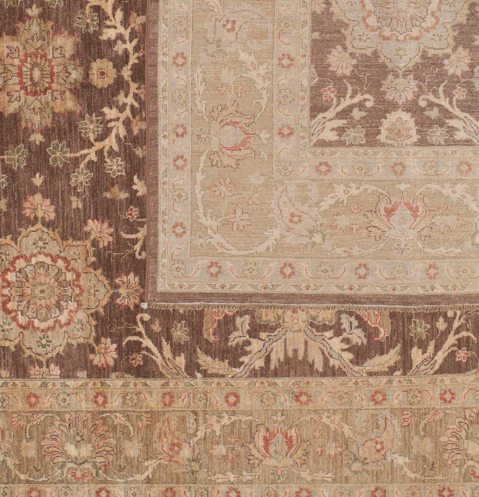 The floral elements of this traditional Pakistani design come to life with a mix of bright medallions, blossoms and scrolling vines. Brown and beige background with light blue, yellow and red. Wool. Hand knotted in Pakistan using vegetal designs.