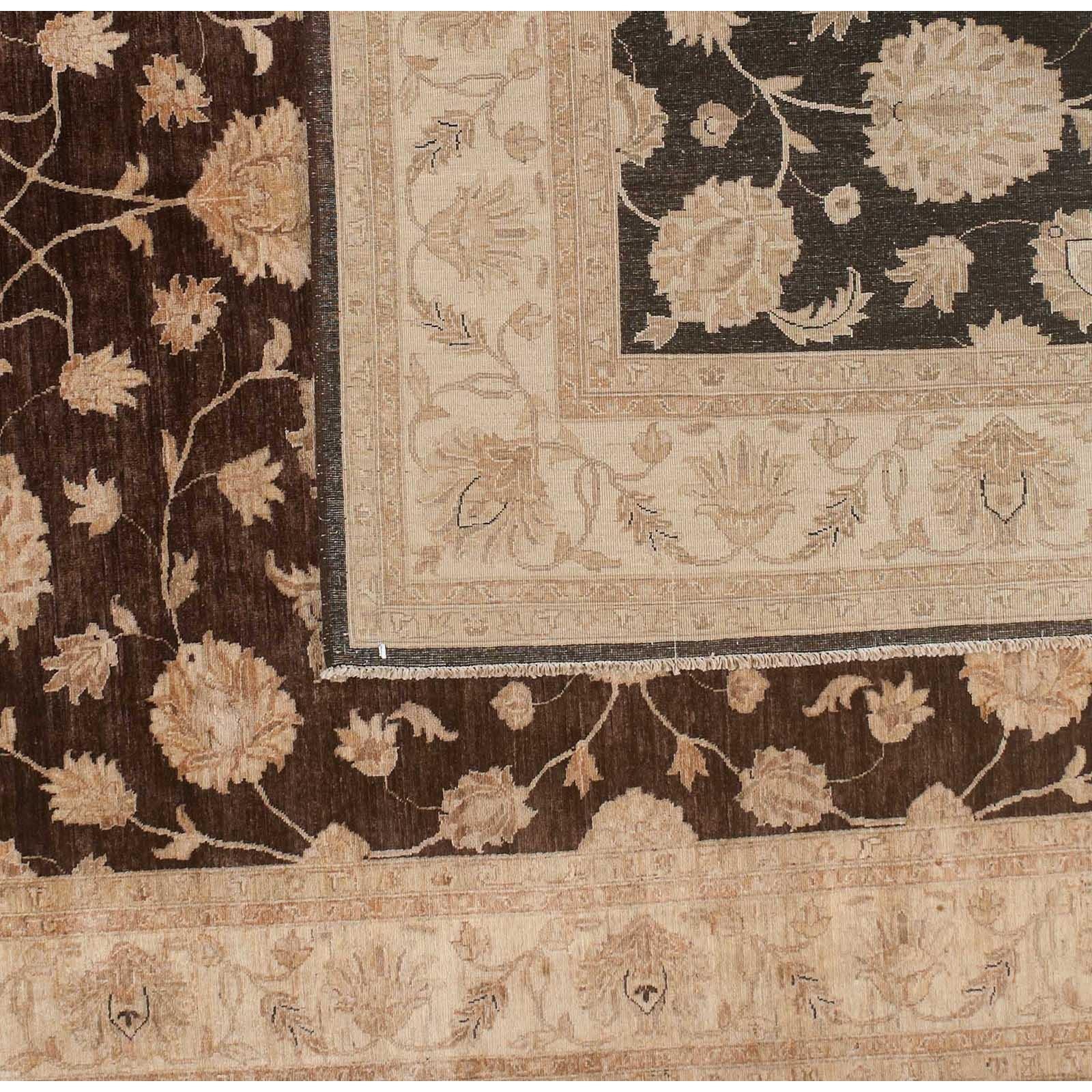 Traditional floral motif area rug with brown core and beige border. Wool. Hand knotted in Pakistan using vegetal dyes.