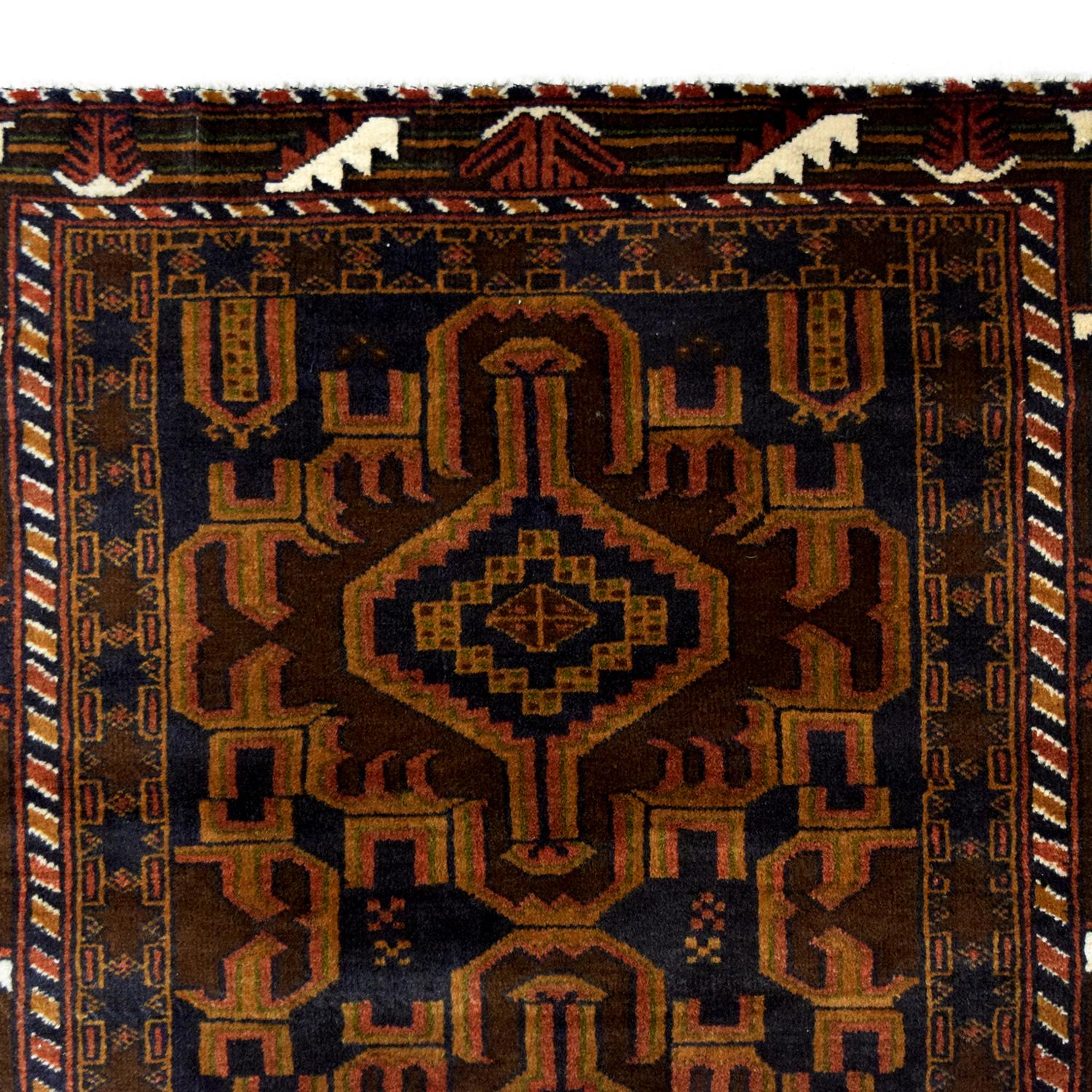 In rich shades of gold, black, red, and cream wool, this traditional Persian Balouchi carpet measures 3’ x 4’7”. Utilizing traditional Persian weaving techniques, this rug has an incredibly soft pile while also possessing superior durability from
