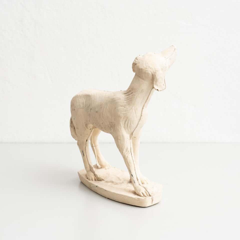 Traditional plaster dog figure.    Made in traditional Catalan atelier in Olot, Spain, circa 1950.    In original condition, with minor wear consistent with age and use, preserving a beautiful patina.    Materials:  Plaster.   