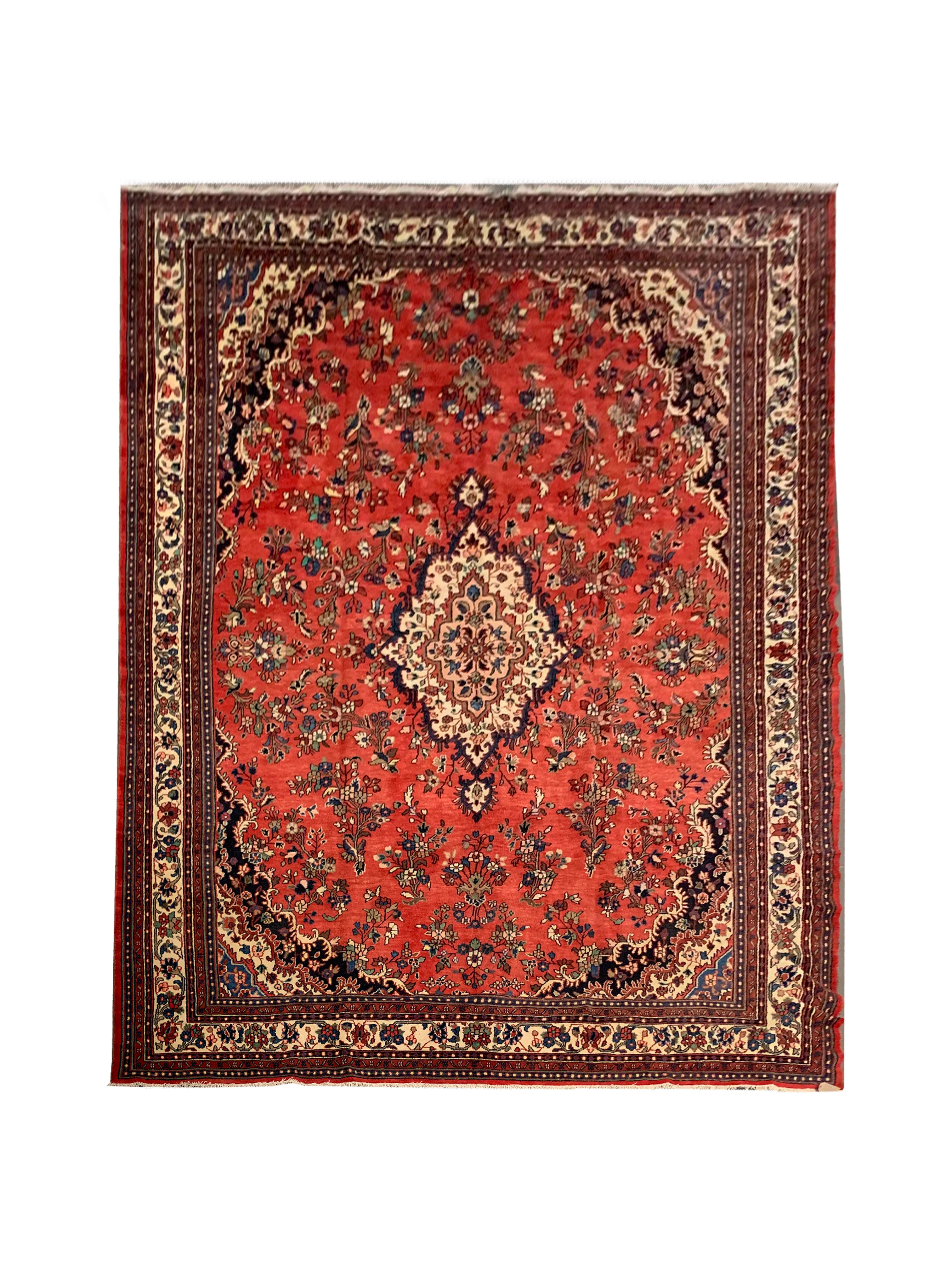 This fantastic accent carpet has been woven with a large red field that has been intricately decorated with a beautiful floral medallion and surrounding design. The medallion is cream with red, blue and pink accents that make up the fine floral