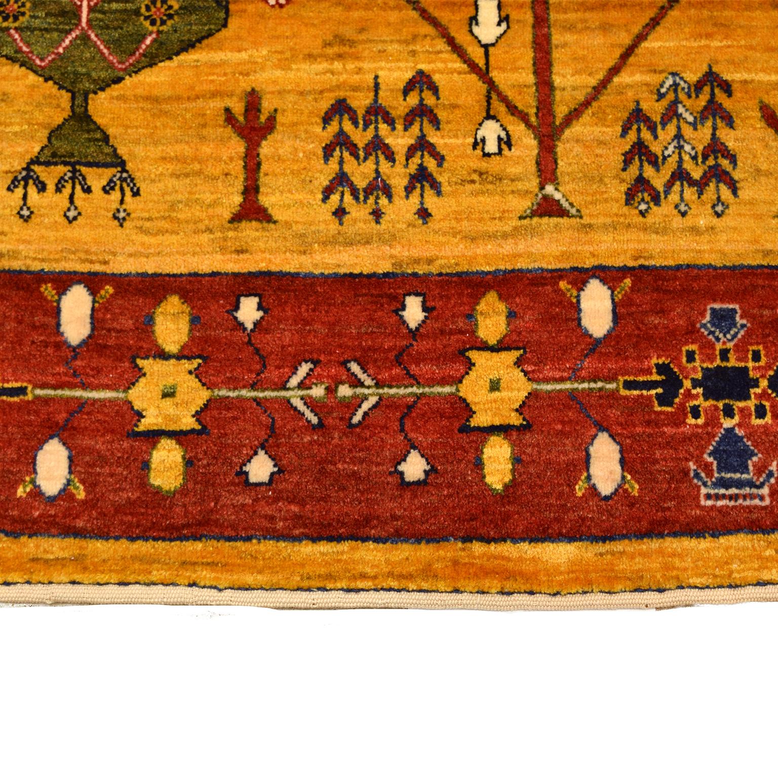 With an asymmetrical design, this traditional, semi-antique Persian Lurestan in red, gold, green, and blue wool measures 3’5” x 4’11” and belongs to Orley Shabahang’s Antique collection. This hand knotted carpet utilizes a Persian weaving technique