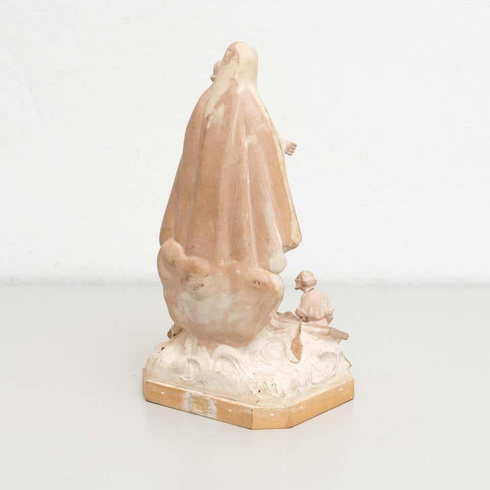 Behold the grace and elegance of this traditional religious plaster figure, depicting the Virgin with timeless beauty. Crafted in a traditional Catalan atelier in Olot, Spain, circa 1950, this exquisite piece captures the essence of devotion and