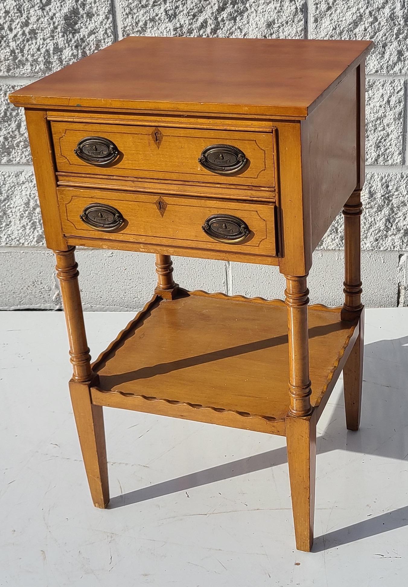 2 Drawer night stand of maple with brass pulls.
Traditional revival piece circa mid 1930s.

