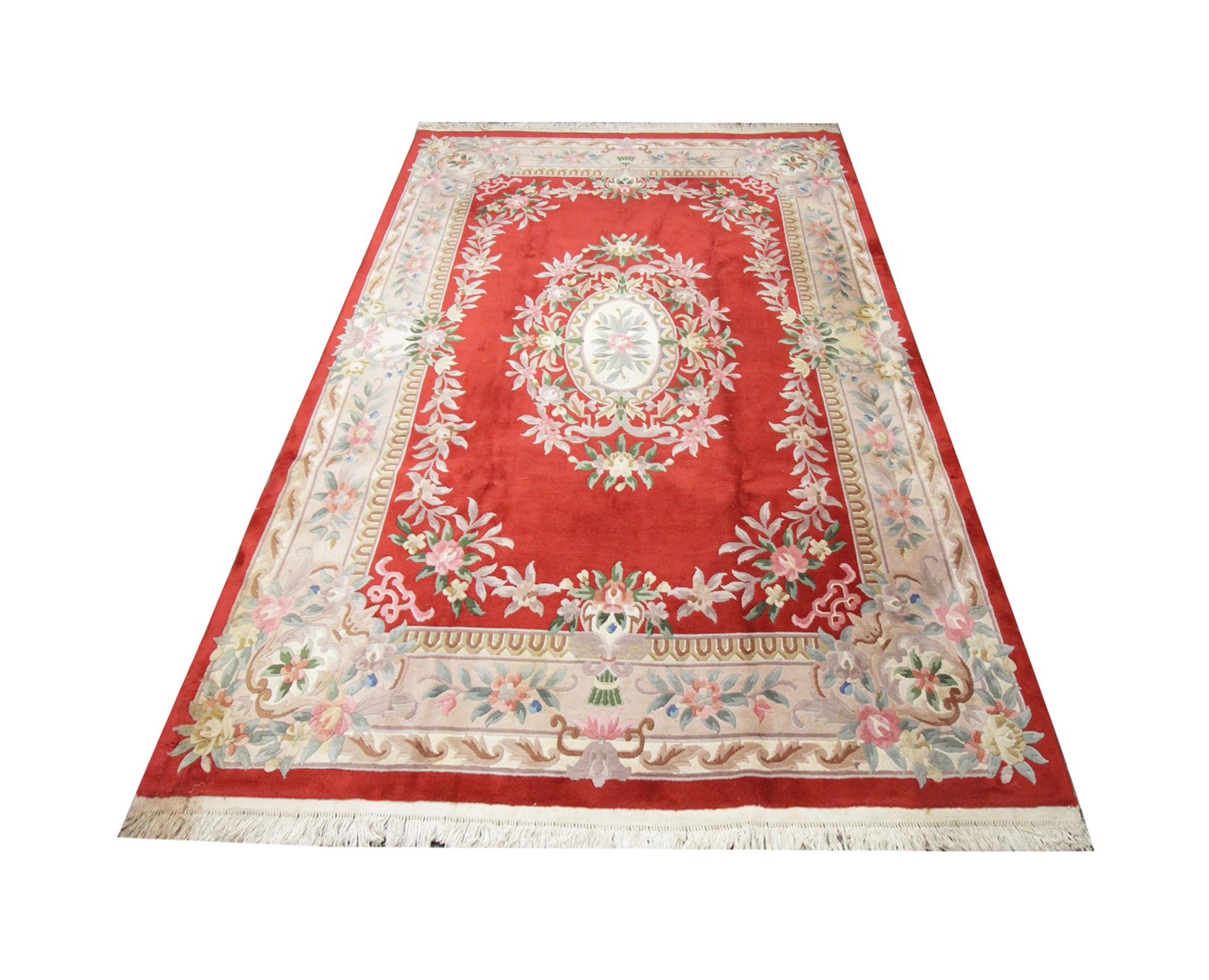 This handmade carpet traditional vintage handwoven Chinese area rug has been handwoven to perfection with a floral meandering border supported on a beige linear background. The central design is a beautiful intricate floral bouquet which sits on a