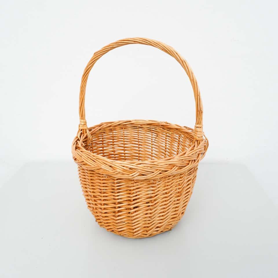 Traditional rustic rattan basket, circa 1960
By unknown Manufacturer. France

In original condition with minor wear consistent of age and use, preserving a beautiful patina.
 
