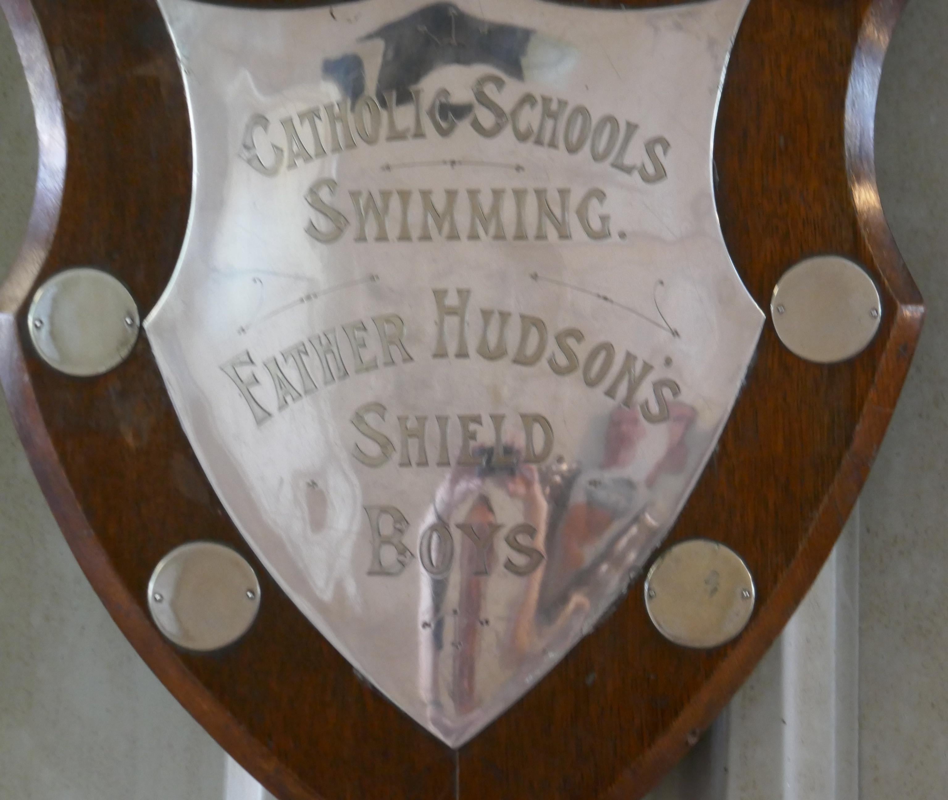 Traditional Shield Swimming Trophy 

The is a traditional golden oak shield has a large silver plated mount, in the centre “CATHOLIC SCHOOLS SWIMMING FATHER HUDSON’S SHIELD BOYS”

The shield is wall hanging, it is in good sound condition though