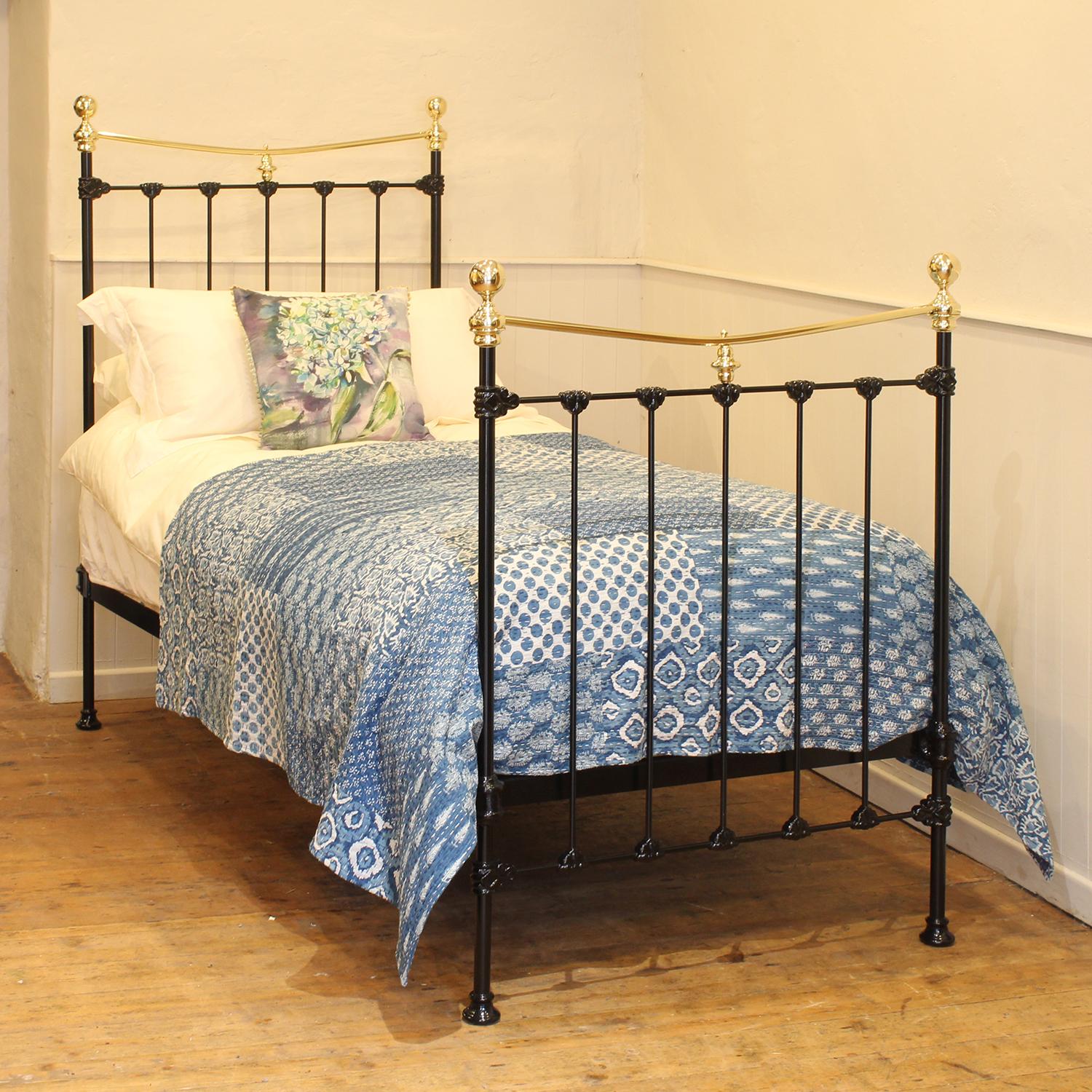 A traditional single Victorian brass and iron antique bed in black, with curved brass top rail, brass collars and round knobs.
This fine original antique bed from the late Victorian era has attractive castings,.
This bed takes a standard UK single